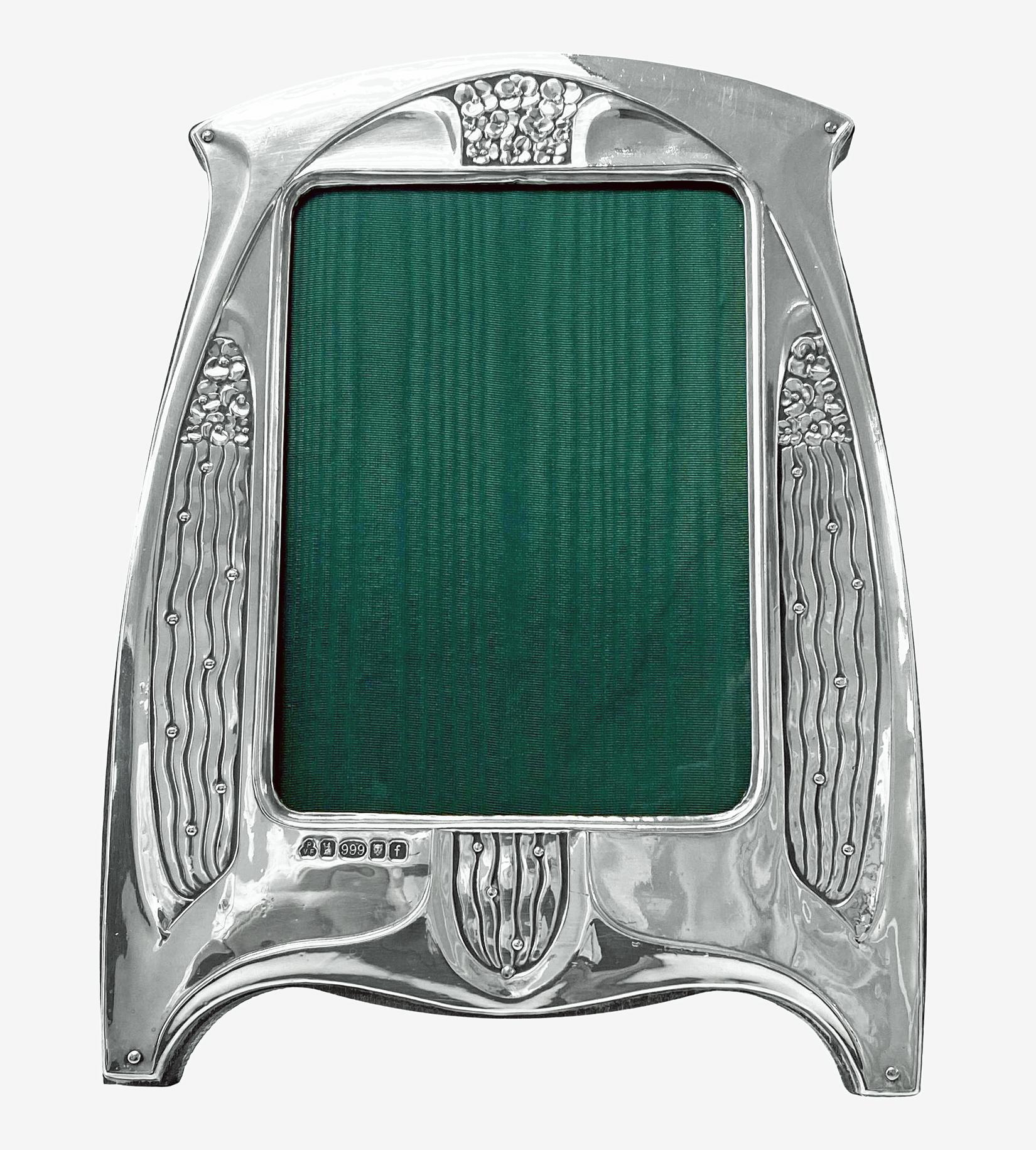 Art Nouveau style .999 Silver (higher than sterling standard) Photo Frame London 2005 Paul Vernon Fitchie. Britannia Mark 0.999 standard Silver Photo Frame with art nouveau arts and crafts foliate decoration, green silk lining wood back and strut.