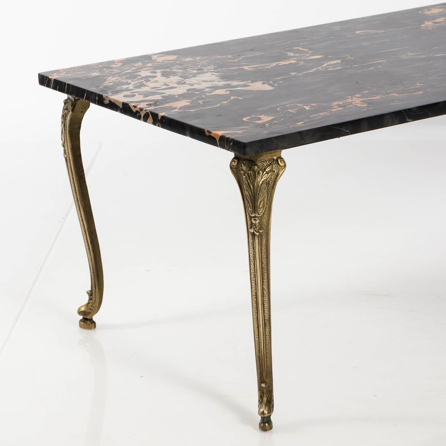 Early 1900s Art Nouveau brass low table with black Egyptian marble top, cabriole legs decorated with a lotus flower motif.
 