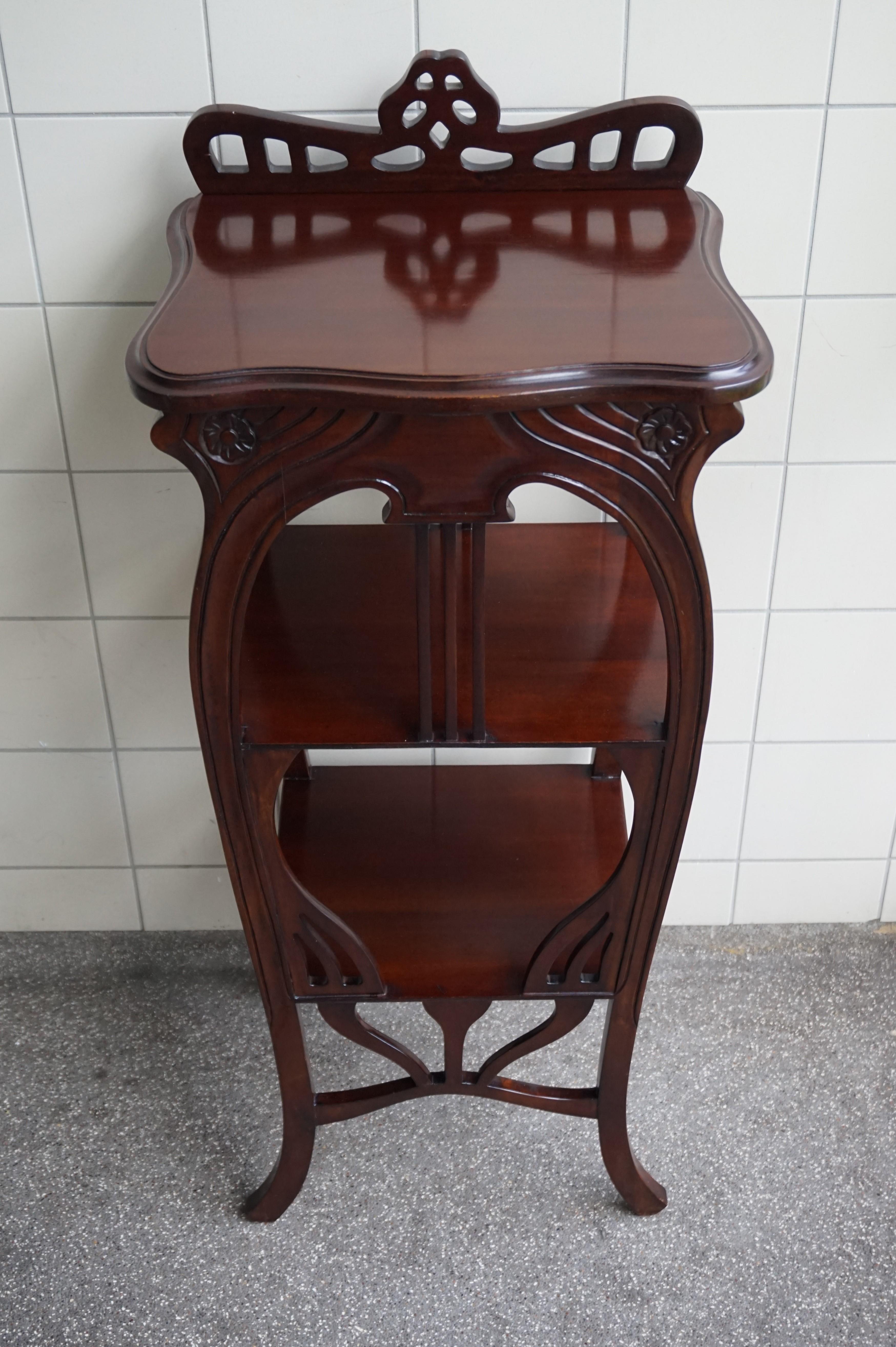 Beautiful and practical Art Nouveau style table.

This fine looking and remarkable condition table in the Art Nouveau style is almost entirely made of solid mahogany or teakwood. Thanks to the elegant shape and the wonderful color it is an absolute