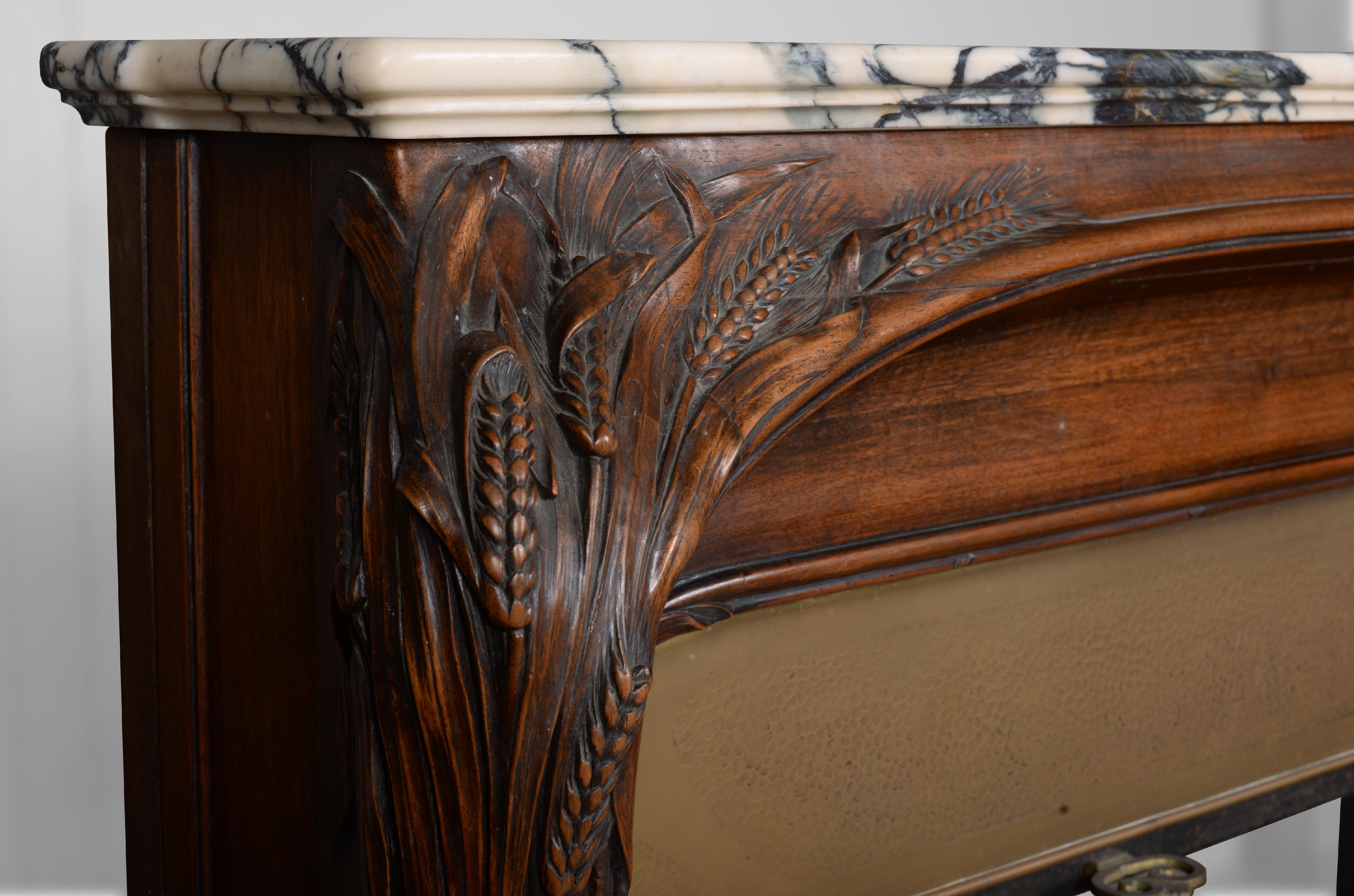 Carved Art Nouveau style fireplace in walnut wood and Panazeau marble