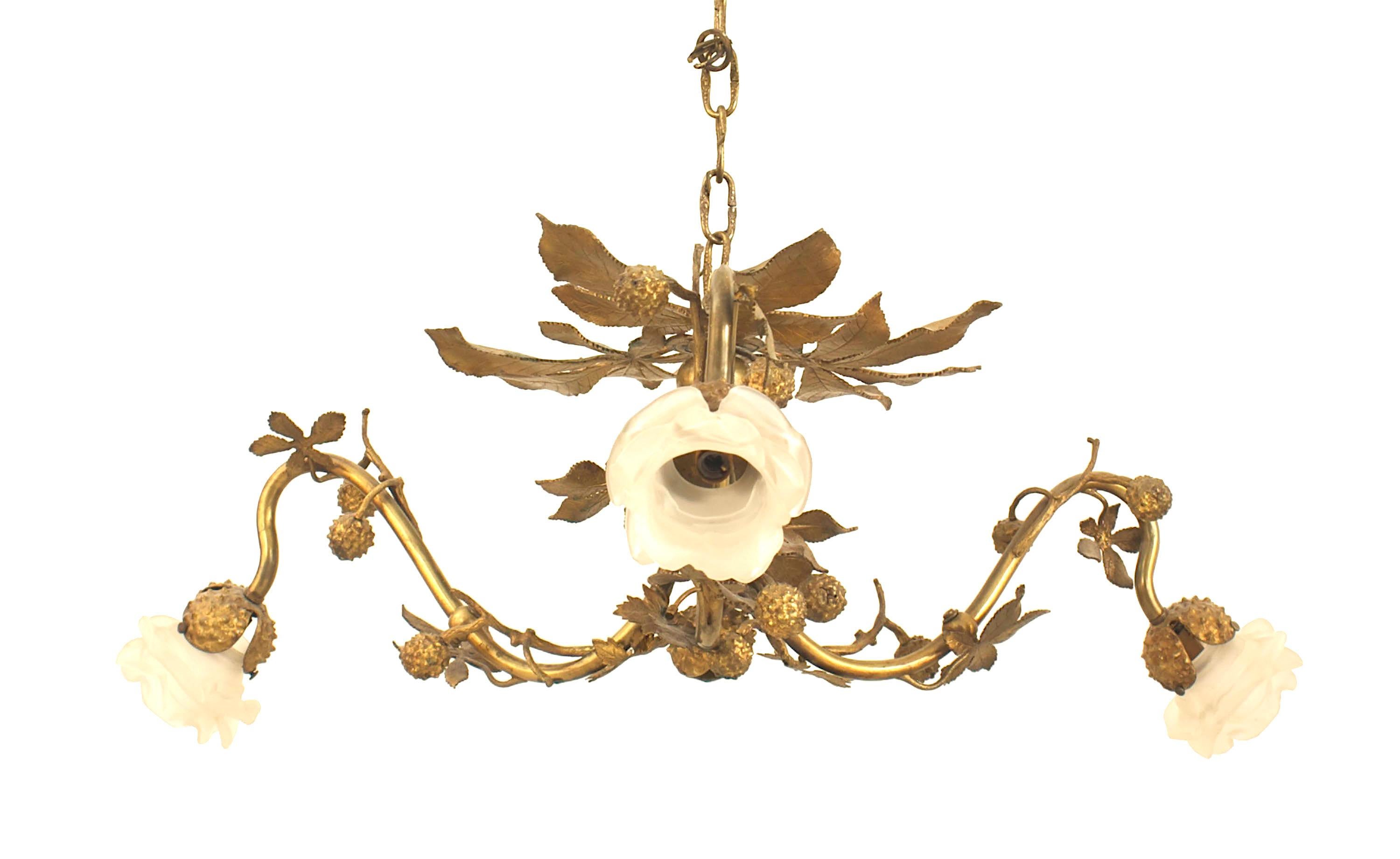 Art Nouveau-style gilt metal rustic style chandelier with 3 arms having design of leaves and berries with 3 frosted glass flower shades.
