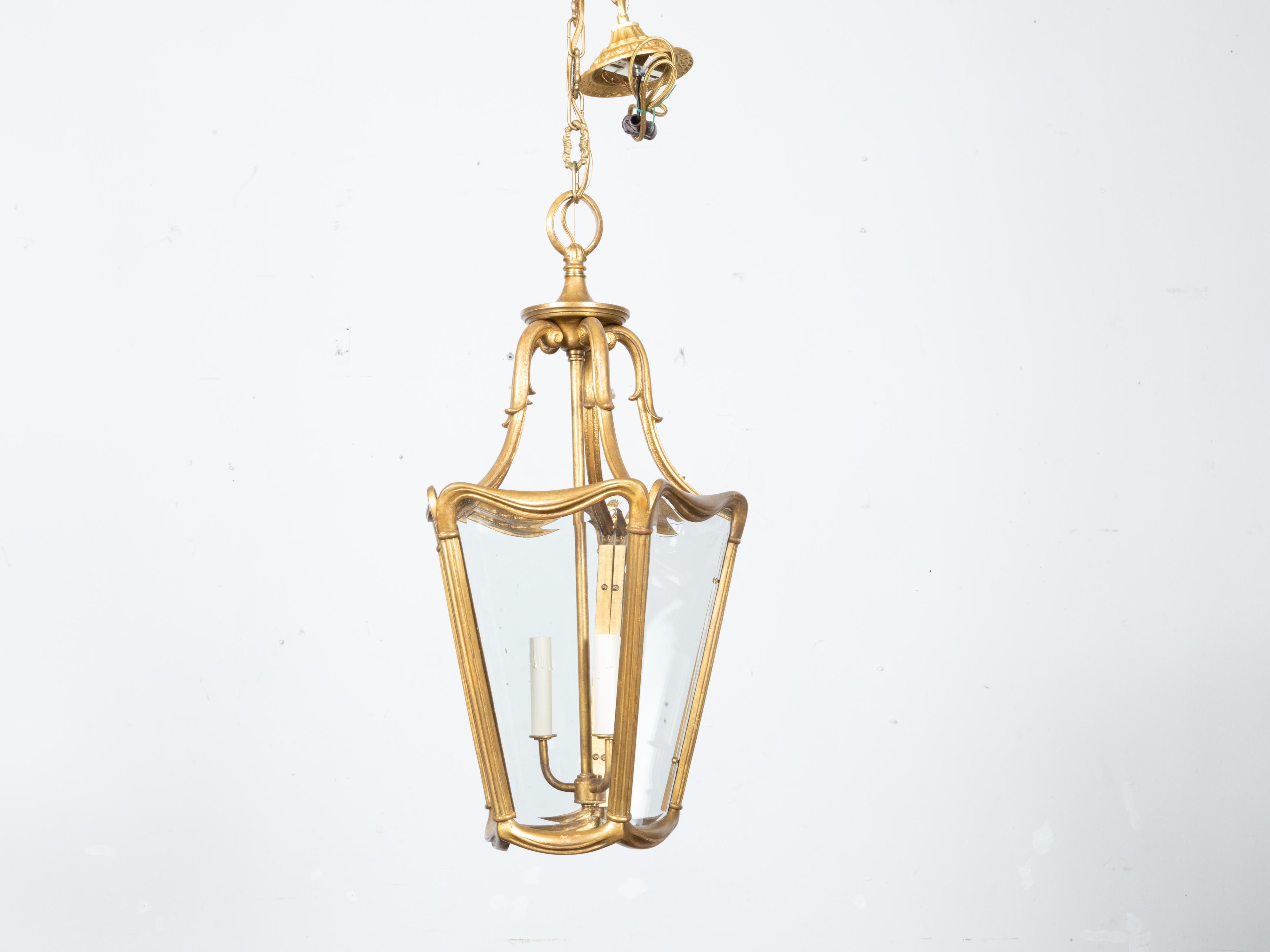 A Midcentury Continental Art Nouveau style gilt metal lantern with three lights. Immerse your space in the classic elegance of the Art Nouveau era with this Continental Midcentury gilt metal lantern. A testament to skilled craftsmanship and refined