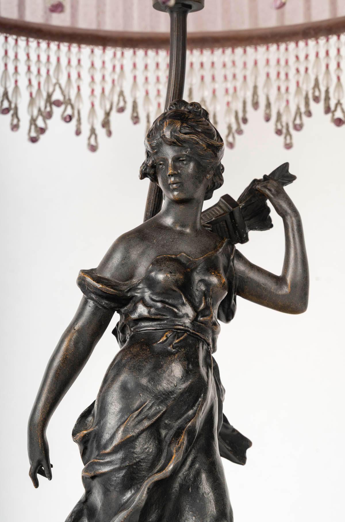 Art Nouveau style lamp, bronze sculpture, and glass shade.

Art Nouveau style table lamp, glass shade, and patinated bronze sculpture depicting Diana the Huntress.
H: 77cm, D: 38cm