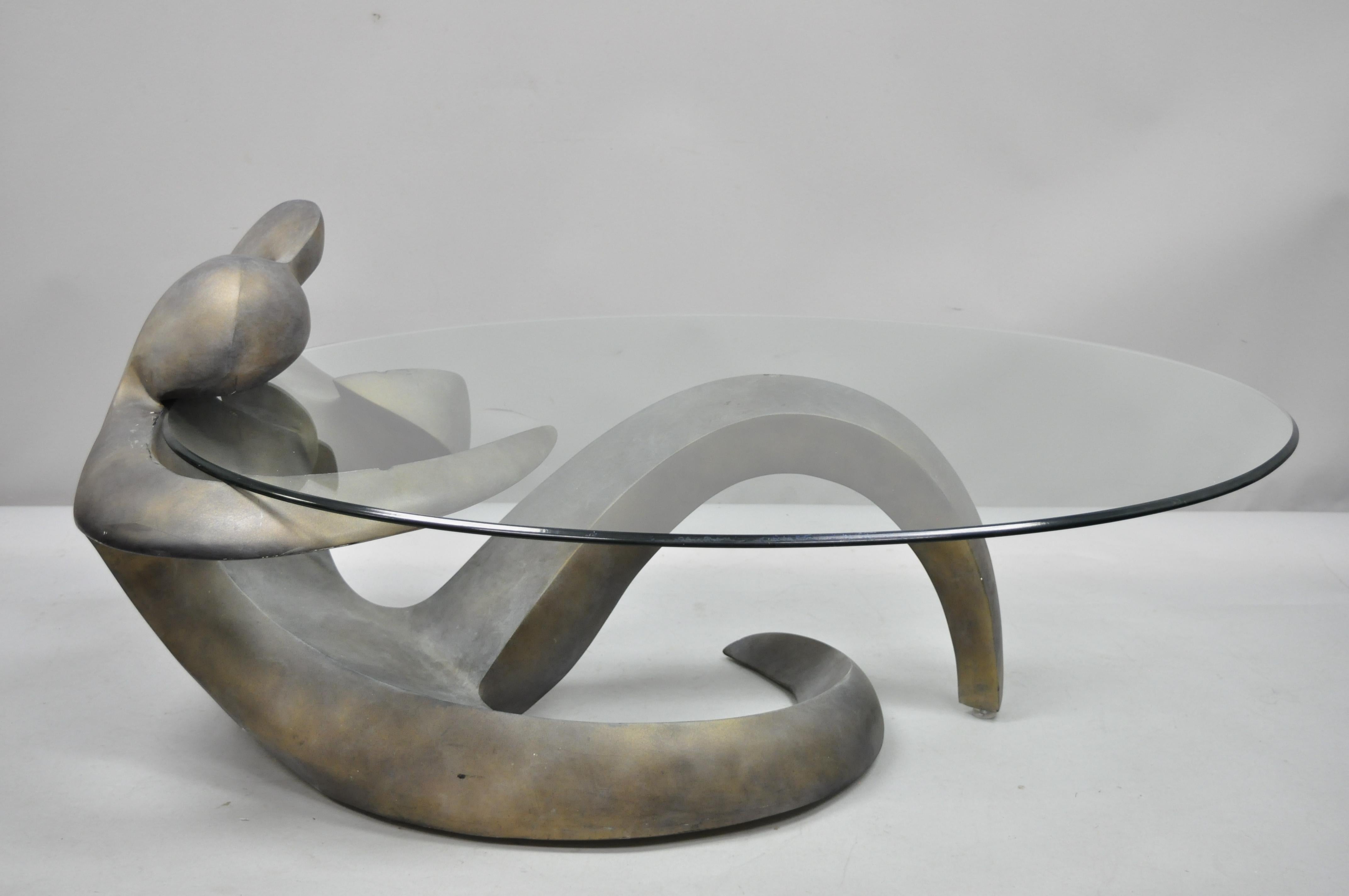 Vintage Mid-Century Modern Picasso style figural female oval glass top coffee table. Item features a sculptural woman form composition base, thick beveled oval glass cantilever style top, gray finish, sleek sculptural form, heavy substantial weight,