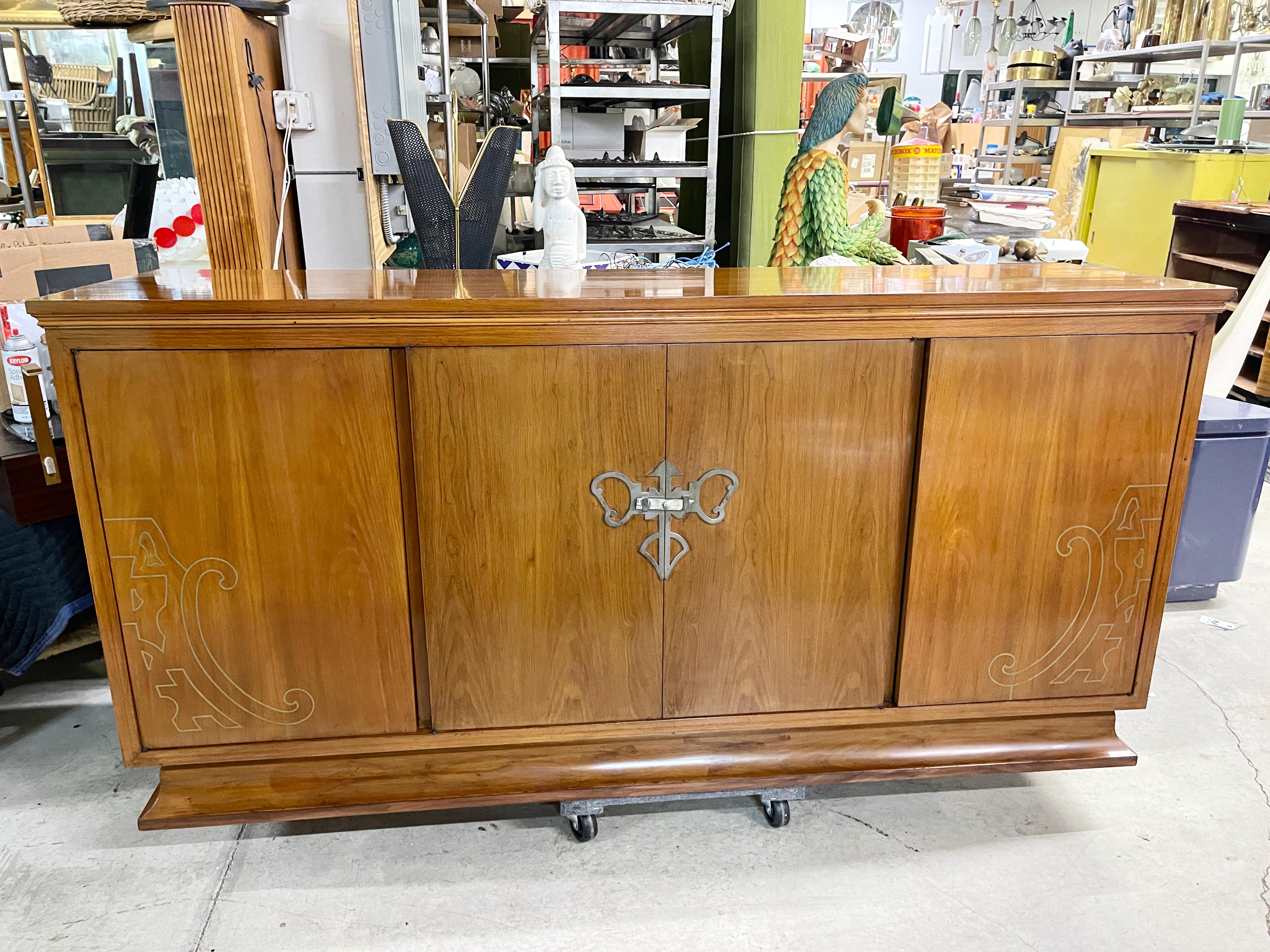 Early 1960's vintage custom made French walnut sideboard with illuminated bar cabinet having distinctive Jugendstil/fin-de-siecle/art nouveau style brass inlay within the left and right doors and an unusual ornamental latch made of patinated metal