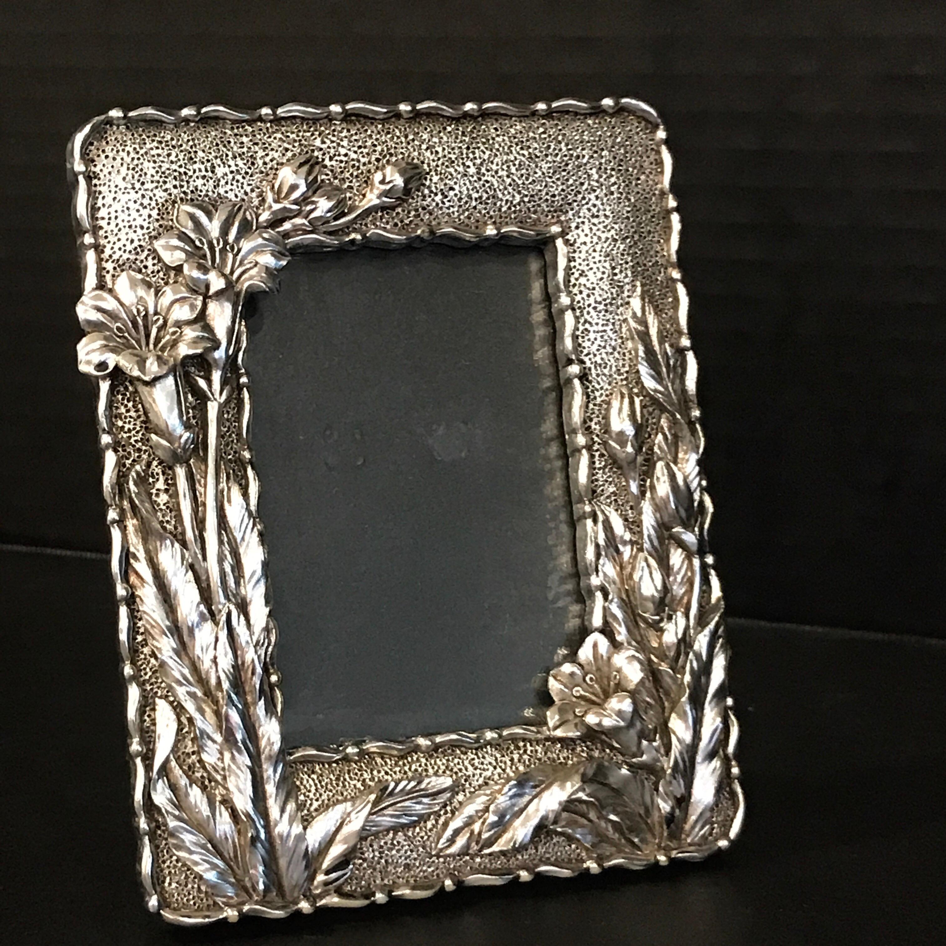 Art Nouveau style silver plated frame, with repoused floral motif, unmarked. Holds a 2