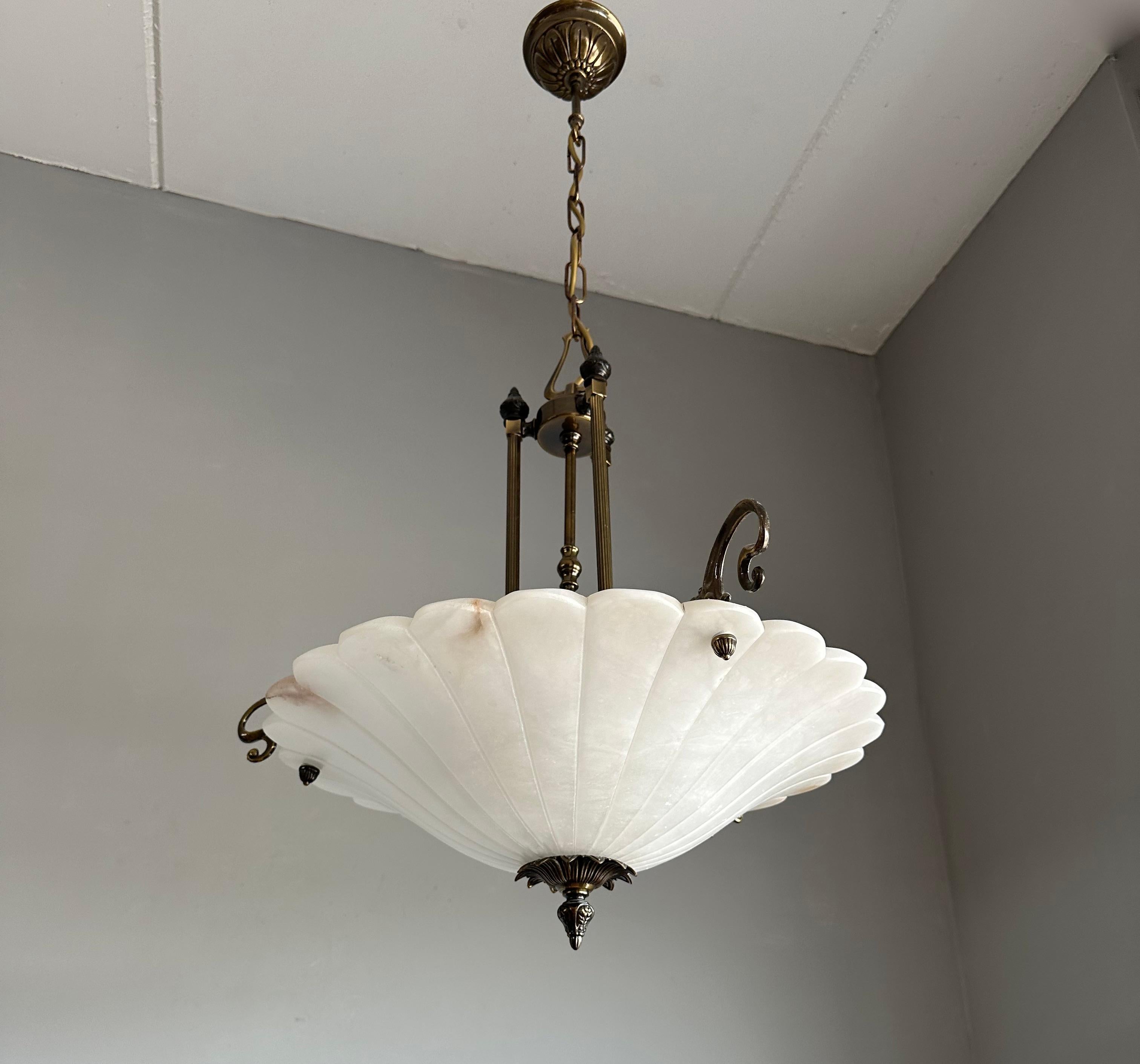 Excellent condition and rare design, 3-light chandelier.

If you appreciate the elegant designs from the Art Nouveau era, then this midcentury made, 1970s alabaster, bronze and brass chandelier could be perfect for you. The combination of the white