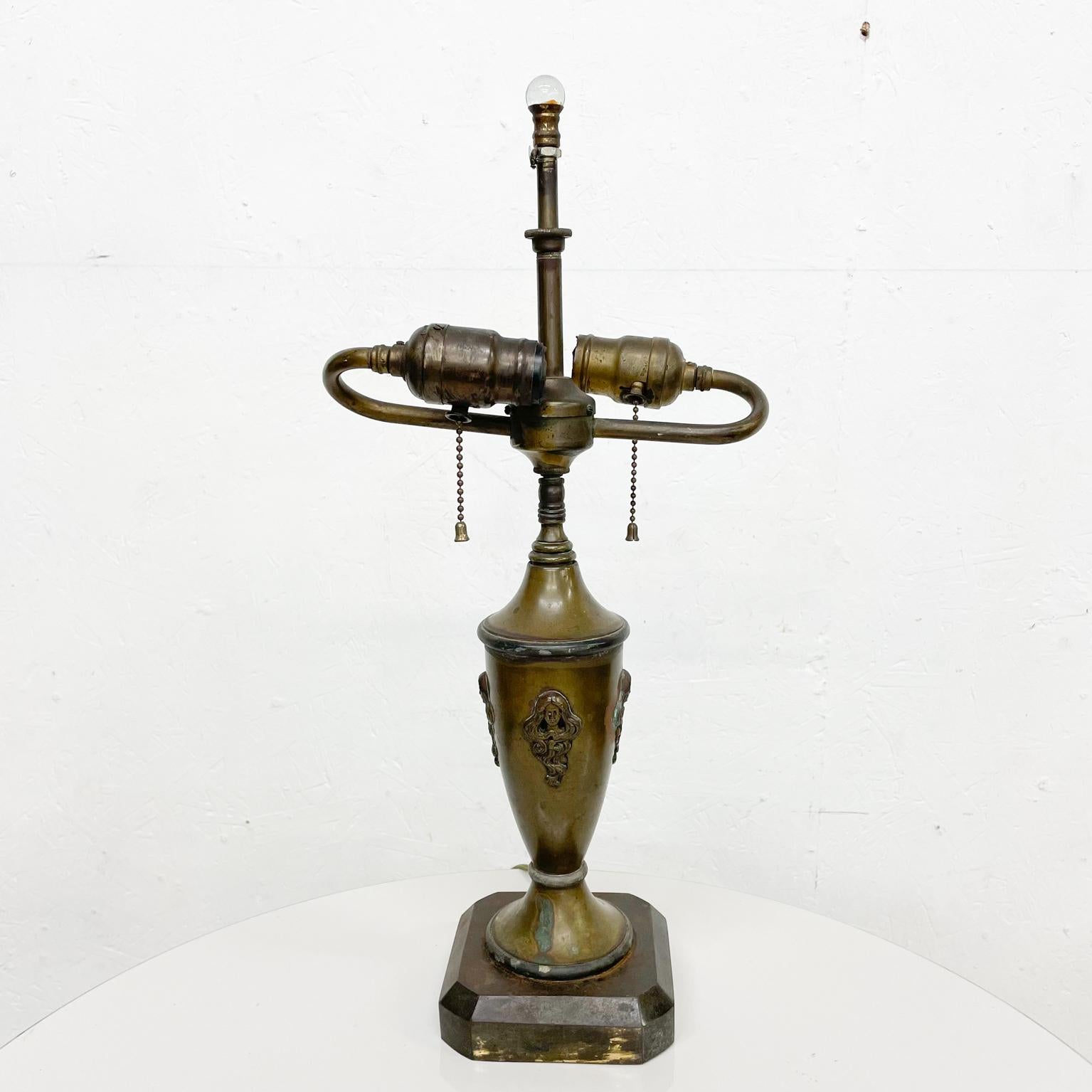 Table lamp
Single table vintage bronze and patinated brass lamp decorative Art Nouveau 
Unmarked
19 H top of glass finial x 9 W x 4.75 D
Original unrestored untested vintage condition. It requires two regular bulbs. No shade. Patina present
See