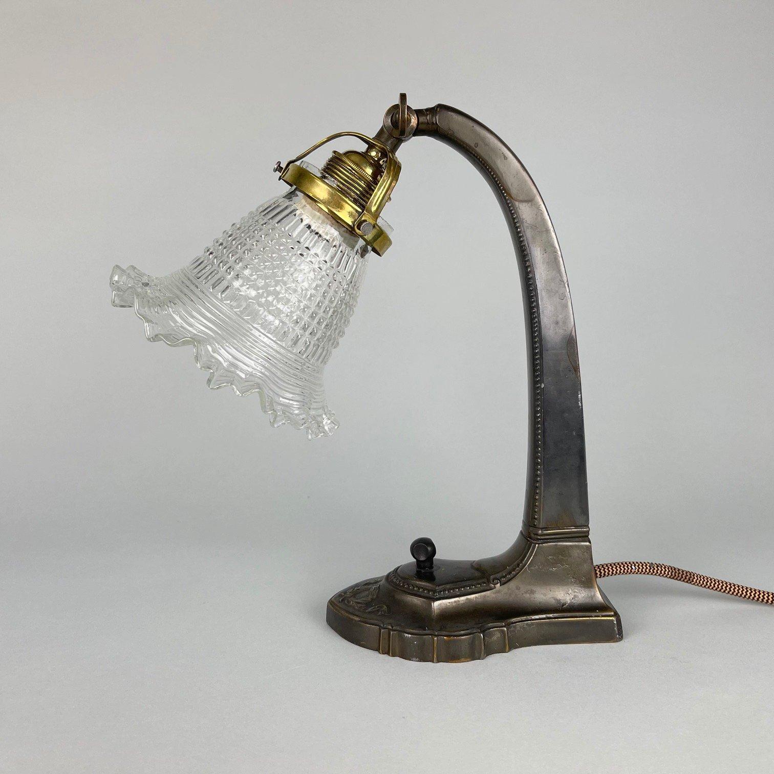 Beautiful antique Art Nouveau lamp made of copper alloy, patinated to old bronze. Produced in former Czechoslovakia in the very beginning of 20th century. 
One-way rotary switch, new wiring, 1 x E25-E27.