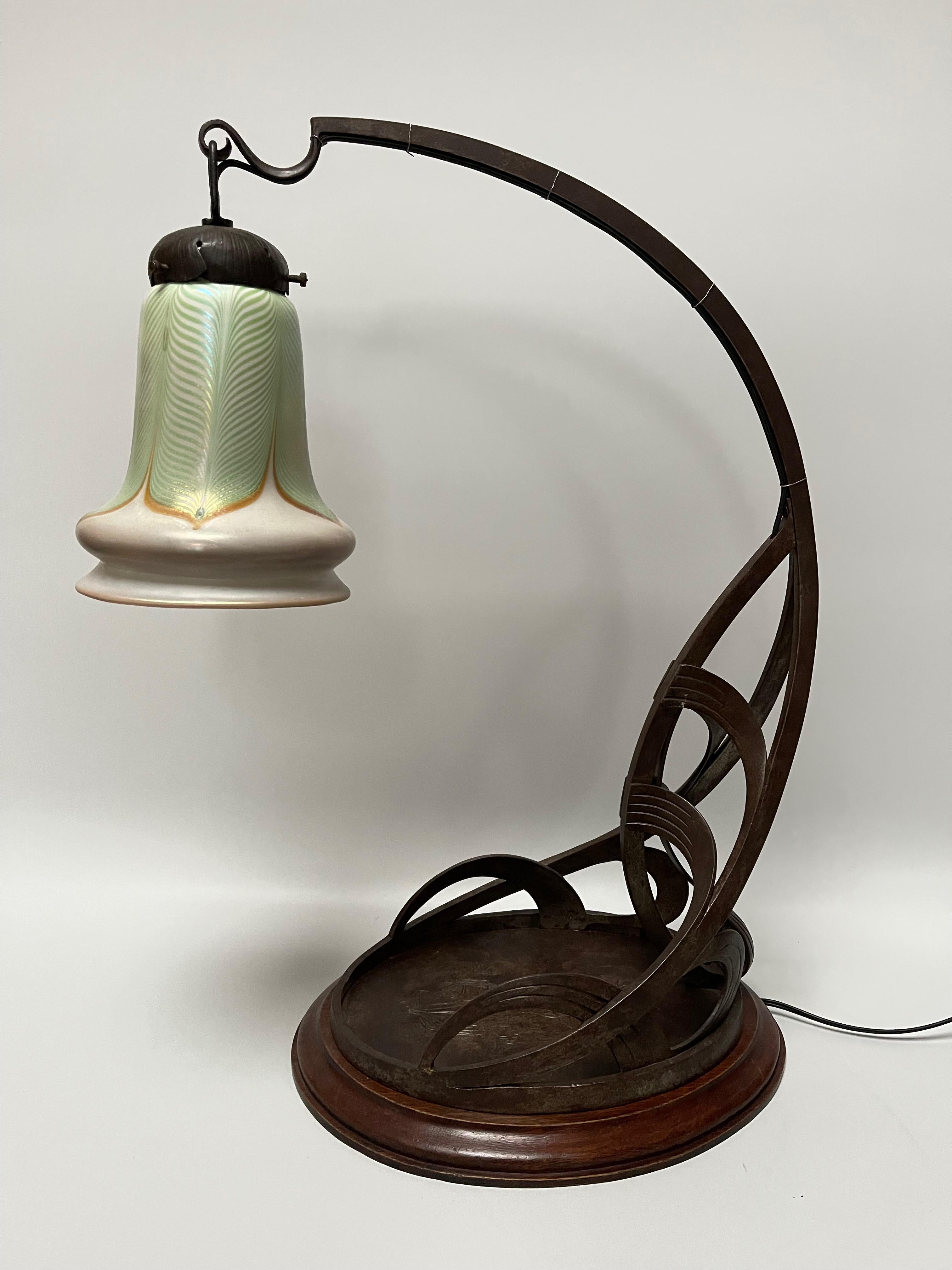 Large art nouveau lamp circa 1900.
Wrought iron frame mounted on a wooden base.
Glass tulip signed Quezal. Signature stamped on the collar of the tuipe.
Wrought iron frame made by Cherpions establishments, signed on the claw of the tulip 