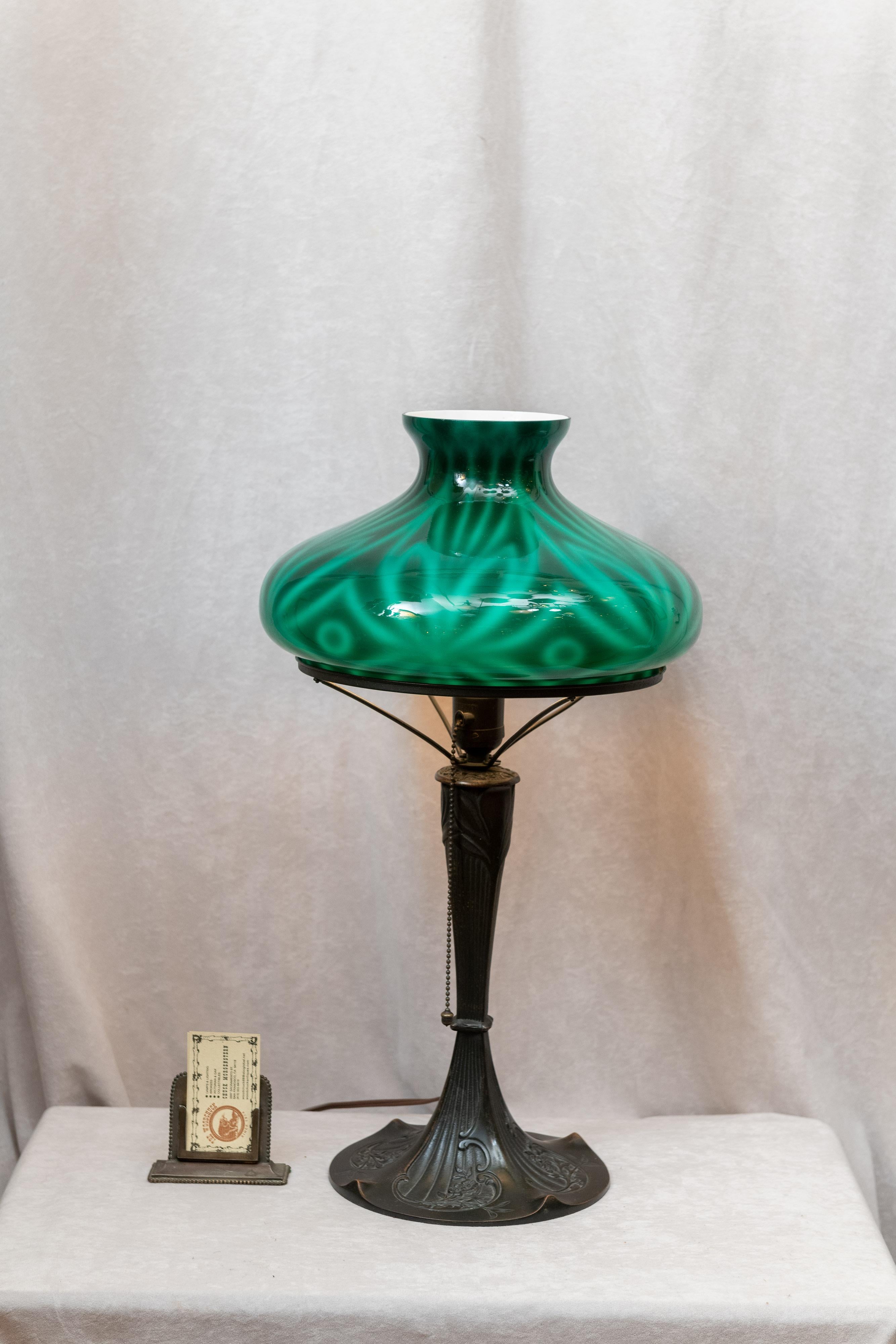 This lamp is really eye catching. I am sorry to say that photographs don't show how beautiful the glass looks in person. While we have seen this particular shade on rare occasions, we have never seen one on such a base as wonderful as this one. The