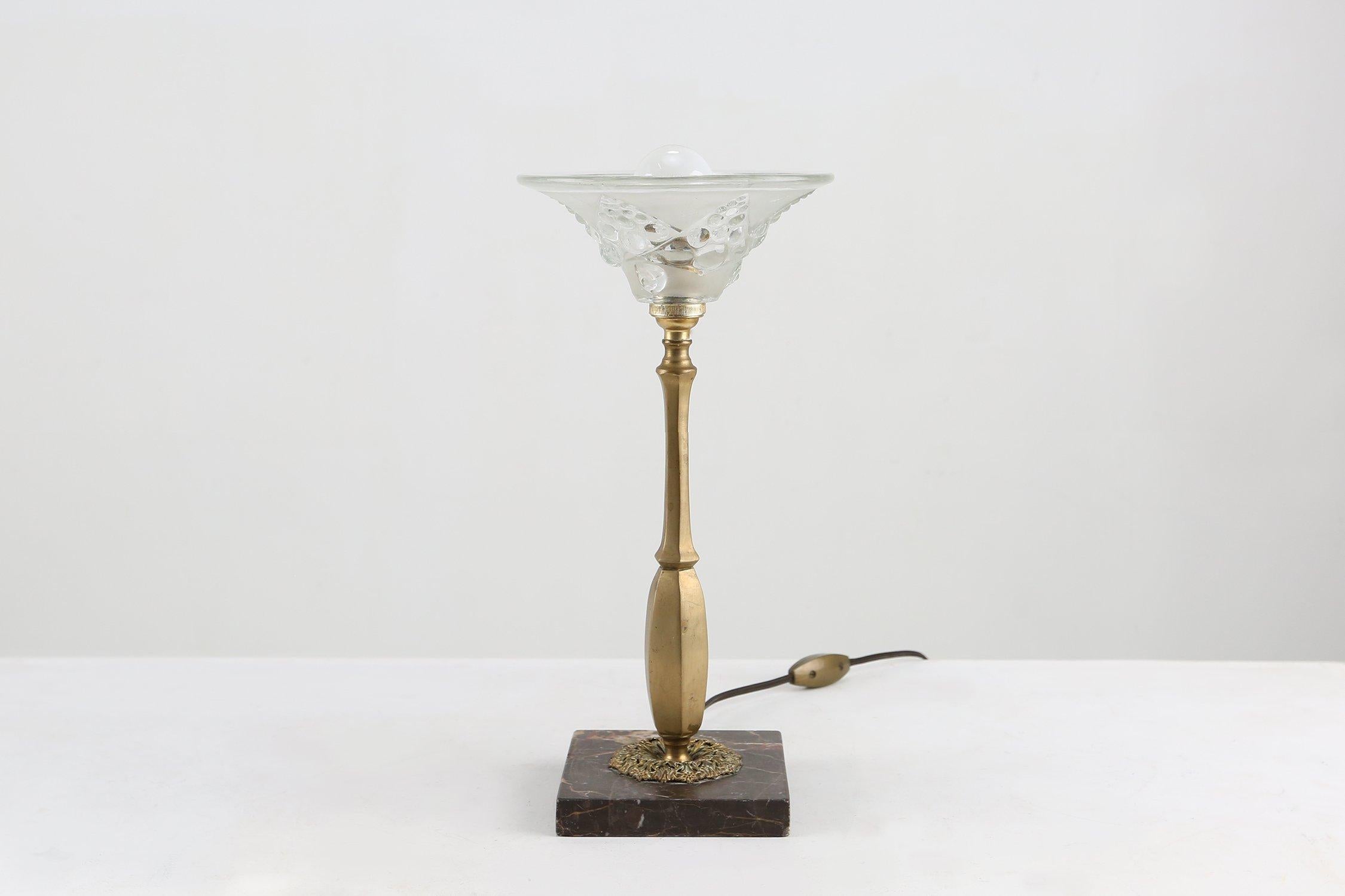 France / 1920 / Table Lamp / brass, glass, marble / Art Nouveau

French Art Nouveau table lamp made around 1920. This rare lamp features a delicate decorated brass stem and black marble base with a opalized glass shade. The shade has nice geometric