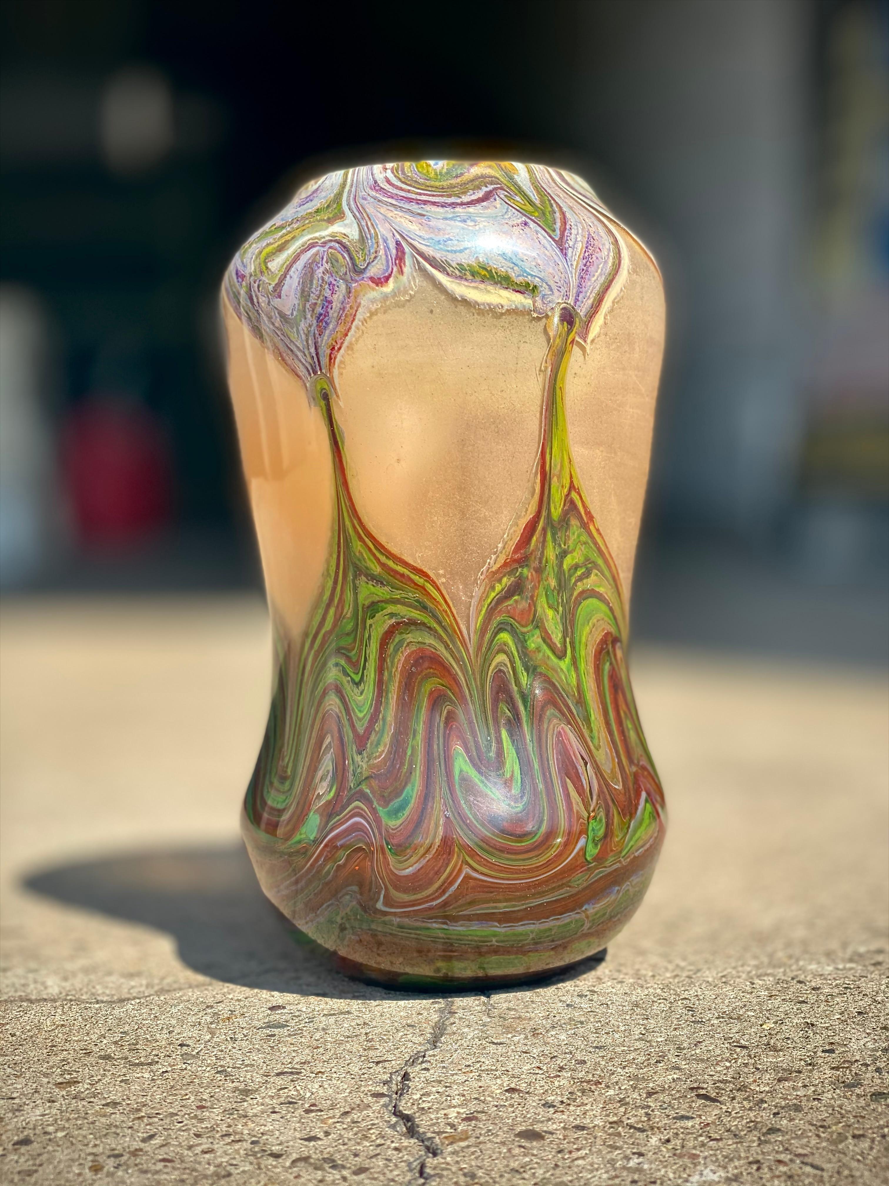 An exceptionally rare American Art Nouveau Tiffany Favrile Reactive paperweight vase decorated with an intense red, mauve, and green heavy swirl decoration throughout furhter leading into an exposed window technique. The interior of the vase is both