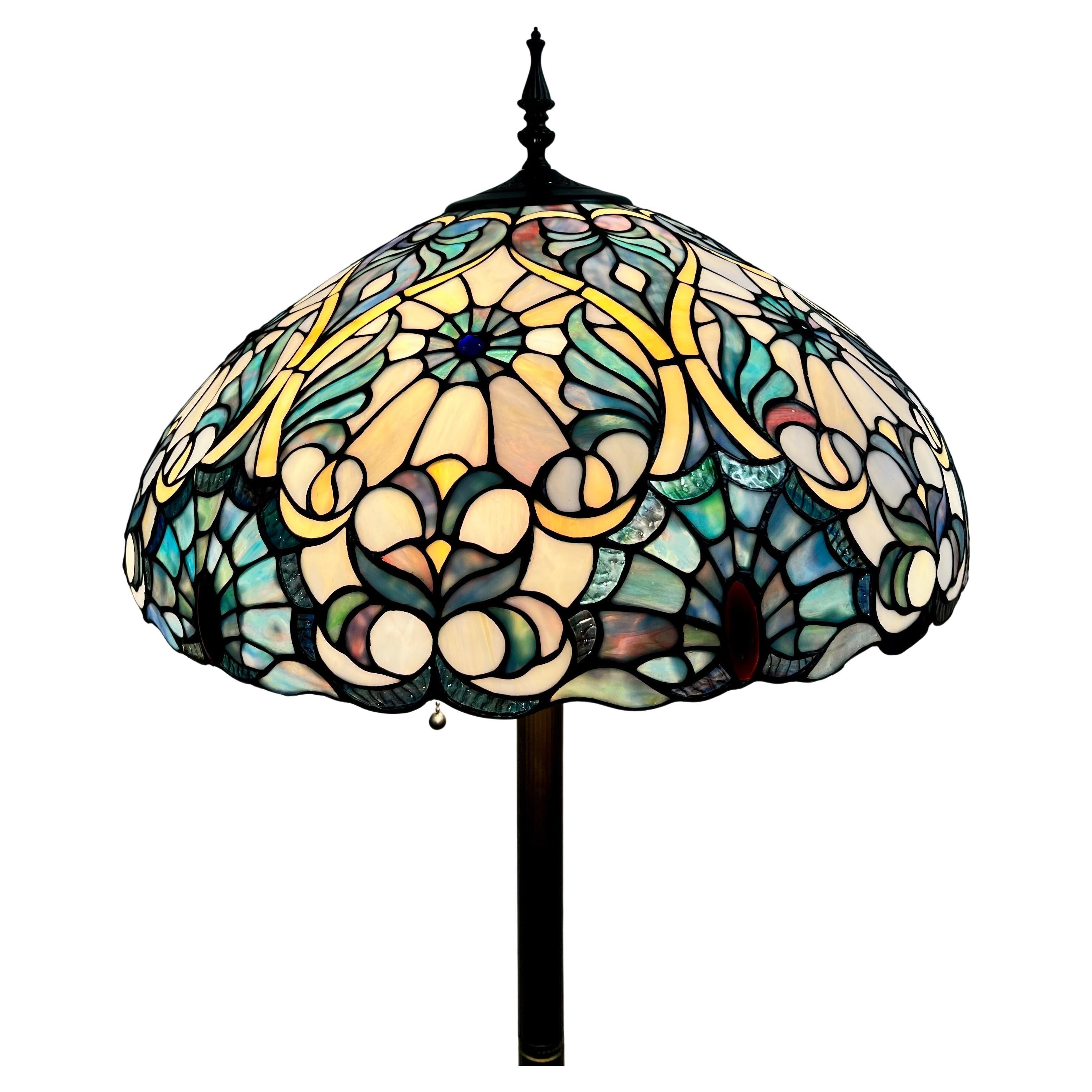 Art Nouveau Tiffany Sale Blue Stained Glass Dome Shaped Shade Floor Lamp :

This elegant Art Nouveau Tiffany-style floor lamp is a stunning fusion of botanical inspiration and luminous artistry, exuding timeless sophistication. The lamp is crowned