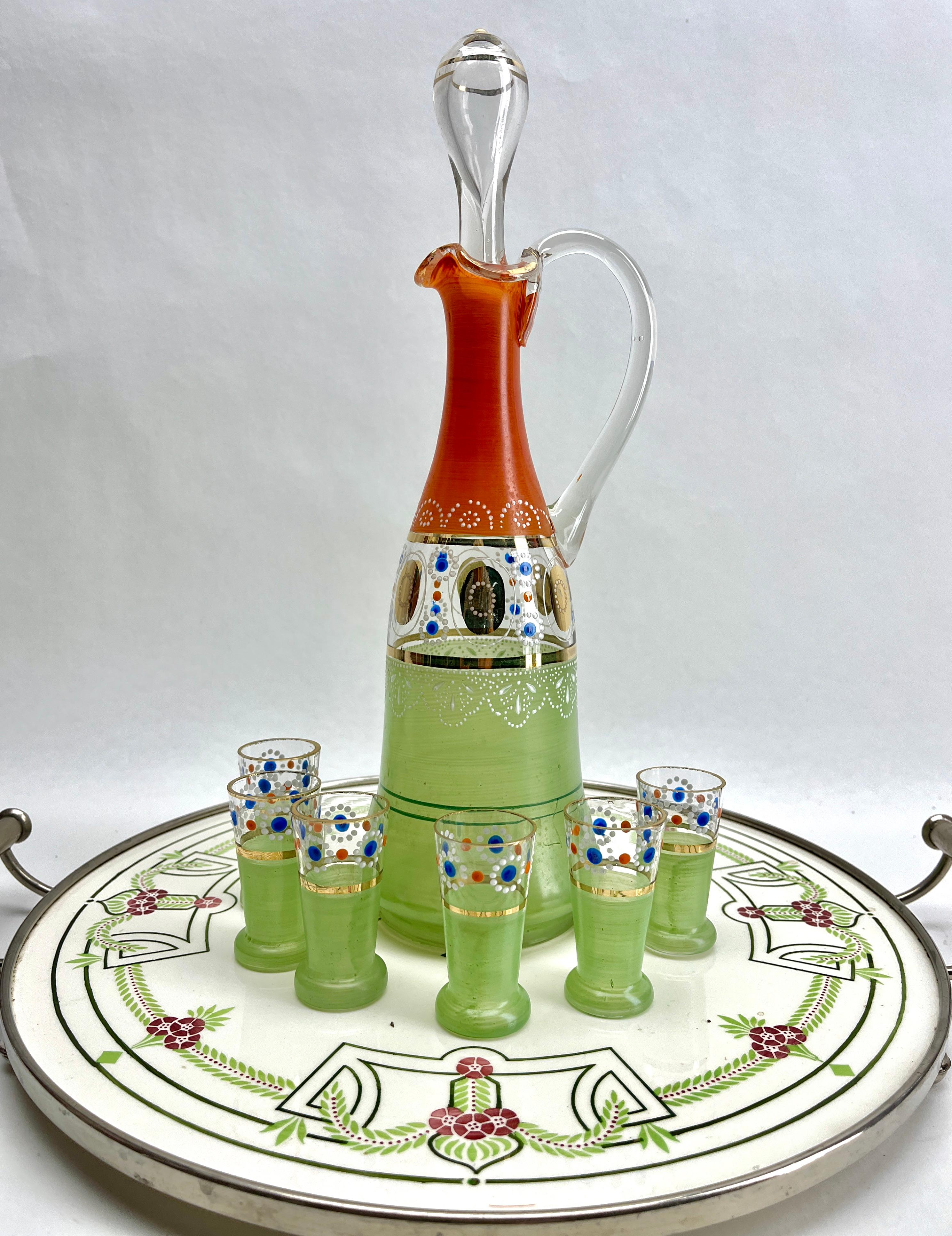 Art Nouveau tile panel with Florale Decoration with Carafe and 6 Shot Glasses
In very nice used condition, circa 1900.
Beautiful Art Nouveau glazed porcelain tableau framed by Metal Handles 
A whole is in a Good Condition
No cracks or chipjes in