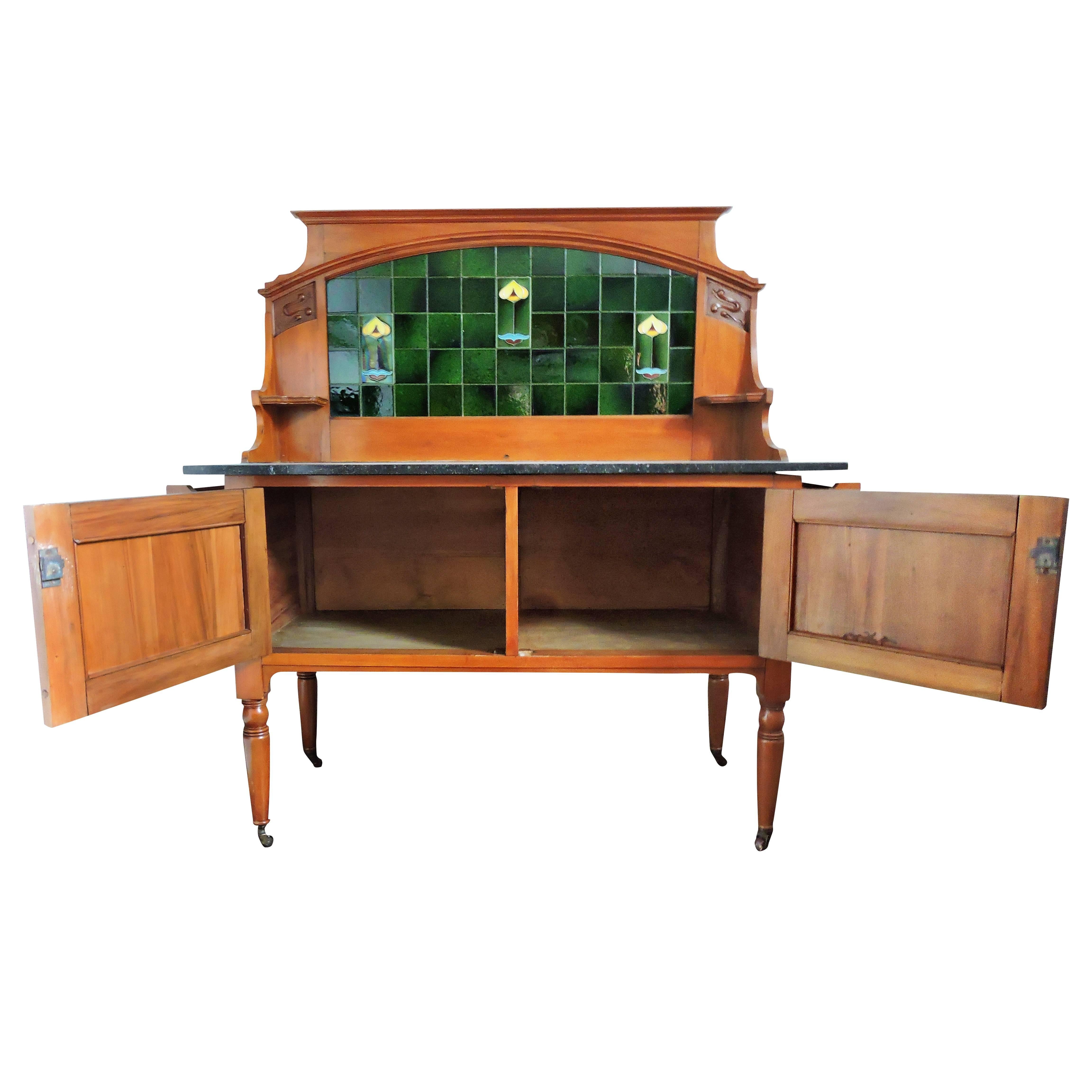 This 19th century walnut, marble topped washstand features tiles.