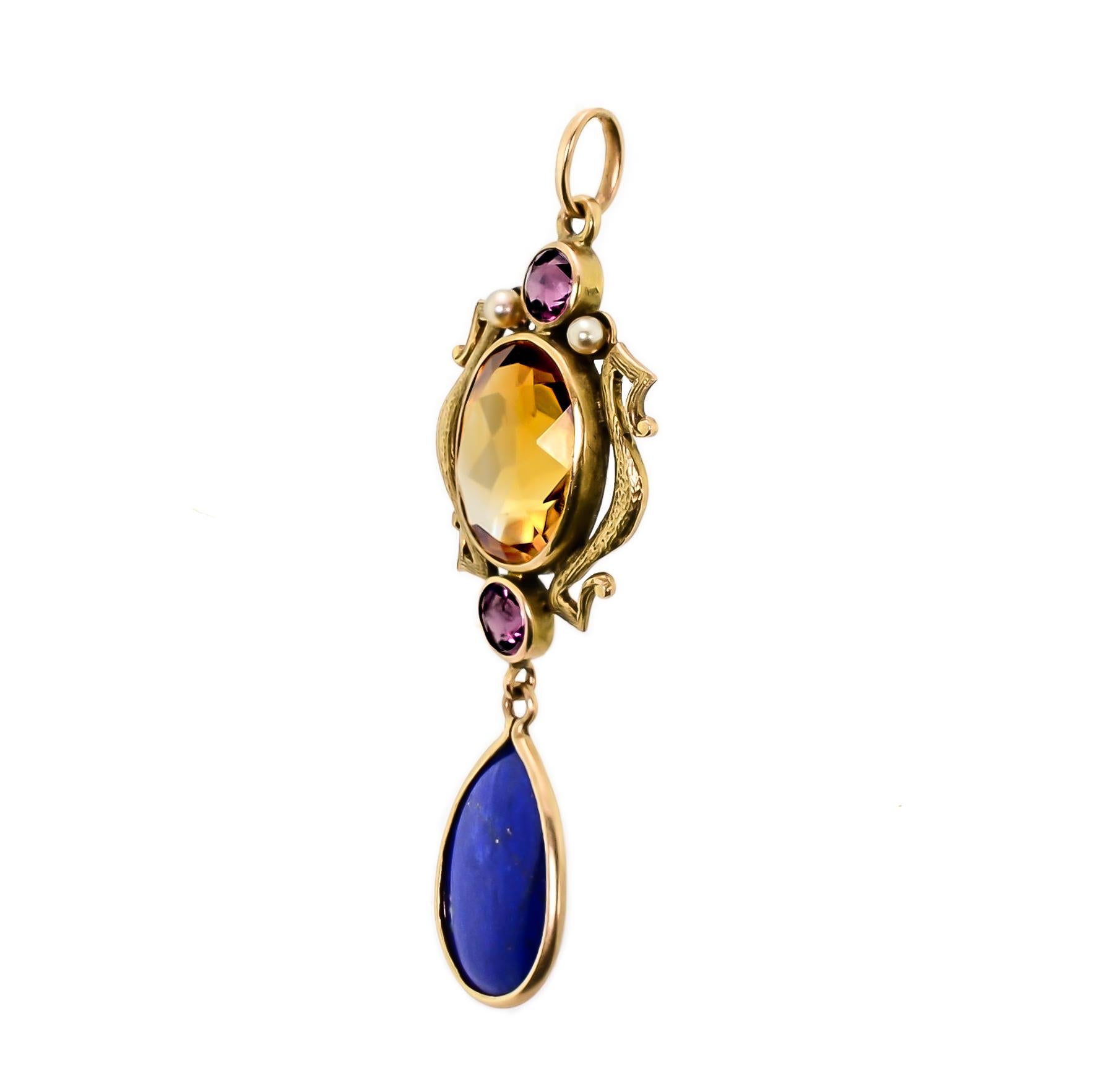 This lovely turn-of-the-century citrine, ruby, and seed pearl 14kt yellow gold pendant from early years of the twentieth century is a beautiful example of the mystical, soft, curvaceous design that defines the Art Nouveau movement. One (1) dazzling