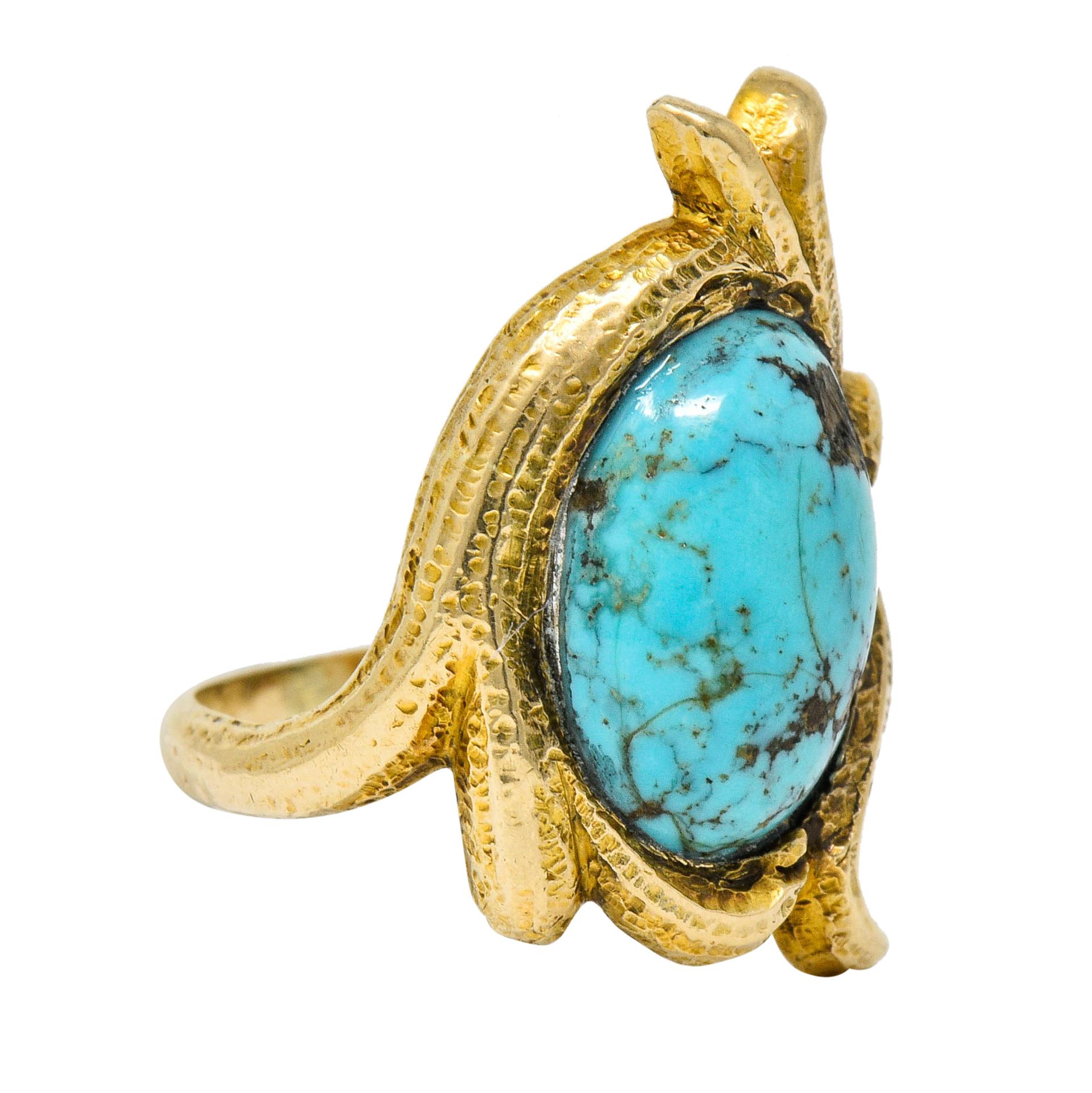 Centering an oval turquoise cabochon measuring approximately 12.0 x 9.0 mm

Opaque with light greenish-blue color and brown matrix

Surrounded by deeply ridged grass-like whiplash

Tested as 14 karat gold

Circa: 1905

Ring Size: 3 1/2 &