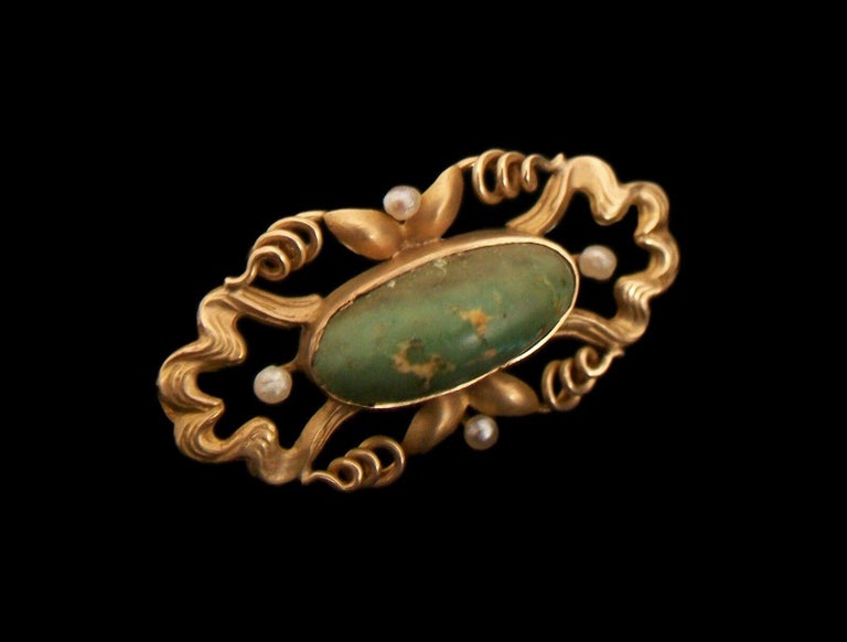 Art Nouveau 14K yellow gold brooch/pin with a 'bloomed' gold finish - hand made featuring organic scrolling tendrils with clam shells and stylized floral details - set with an oval cabochon natural turquoise (1.5 cm x .5 cm x .7 cm) - also set with