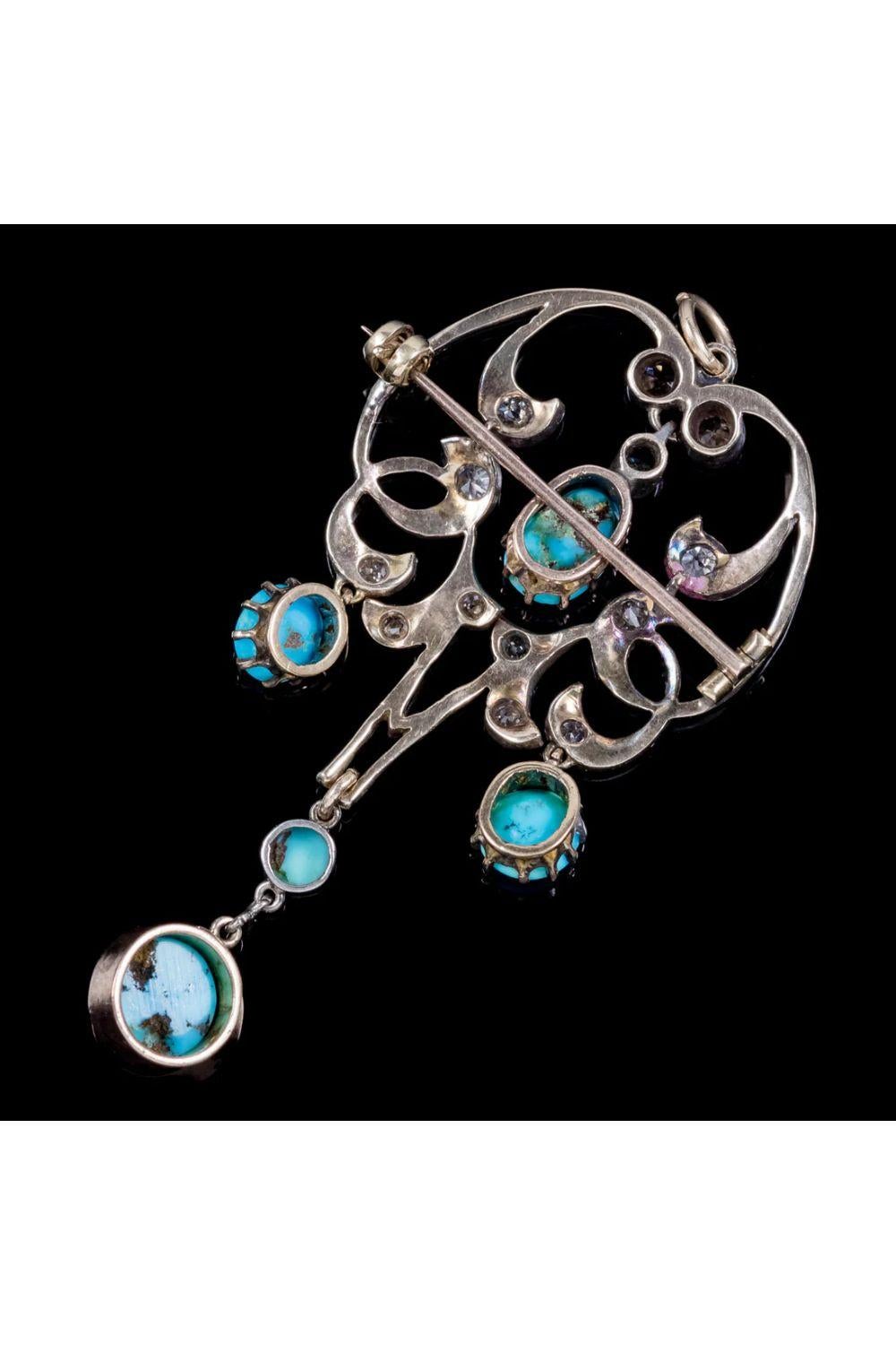 A beautiful antique Art Nouveau pendant from the Edwardian era decorated with glistening old cut diamonds and five natural turquoise droppers.

The largest turquoise is approx. 2ct and hangs from a swinging pendulum at the bottom. The diamonds are