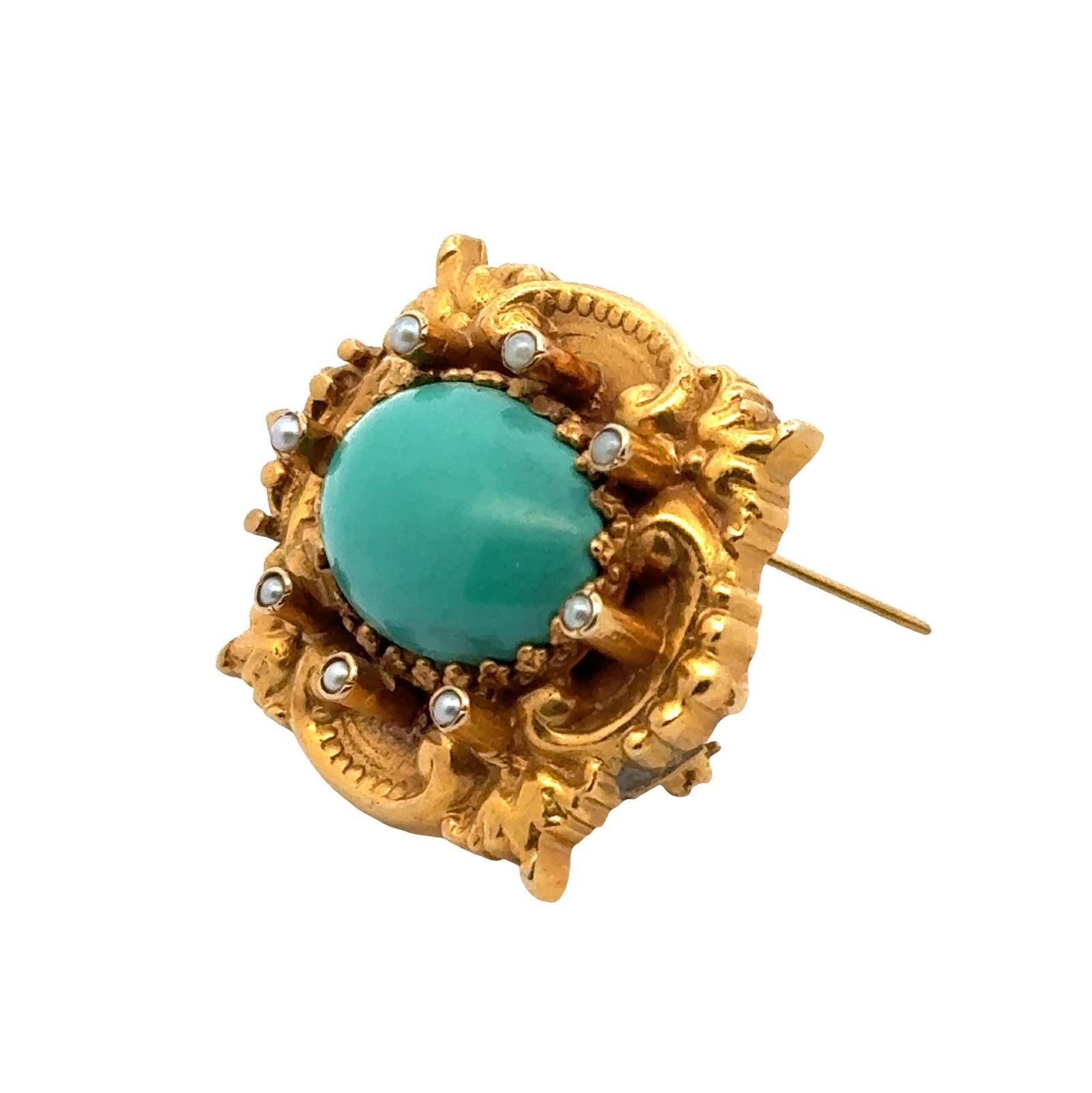 Original Art Nouveau turquoise and seed pearl brooch handcrafted in 14 karat yellow gold. The pin features a natural blue cabochon turquoise gemstone with seed pearl accents. the brooch measures 1.25 x 1.50 inches. Weight: 18 grams.