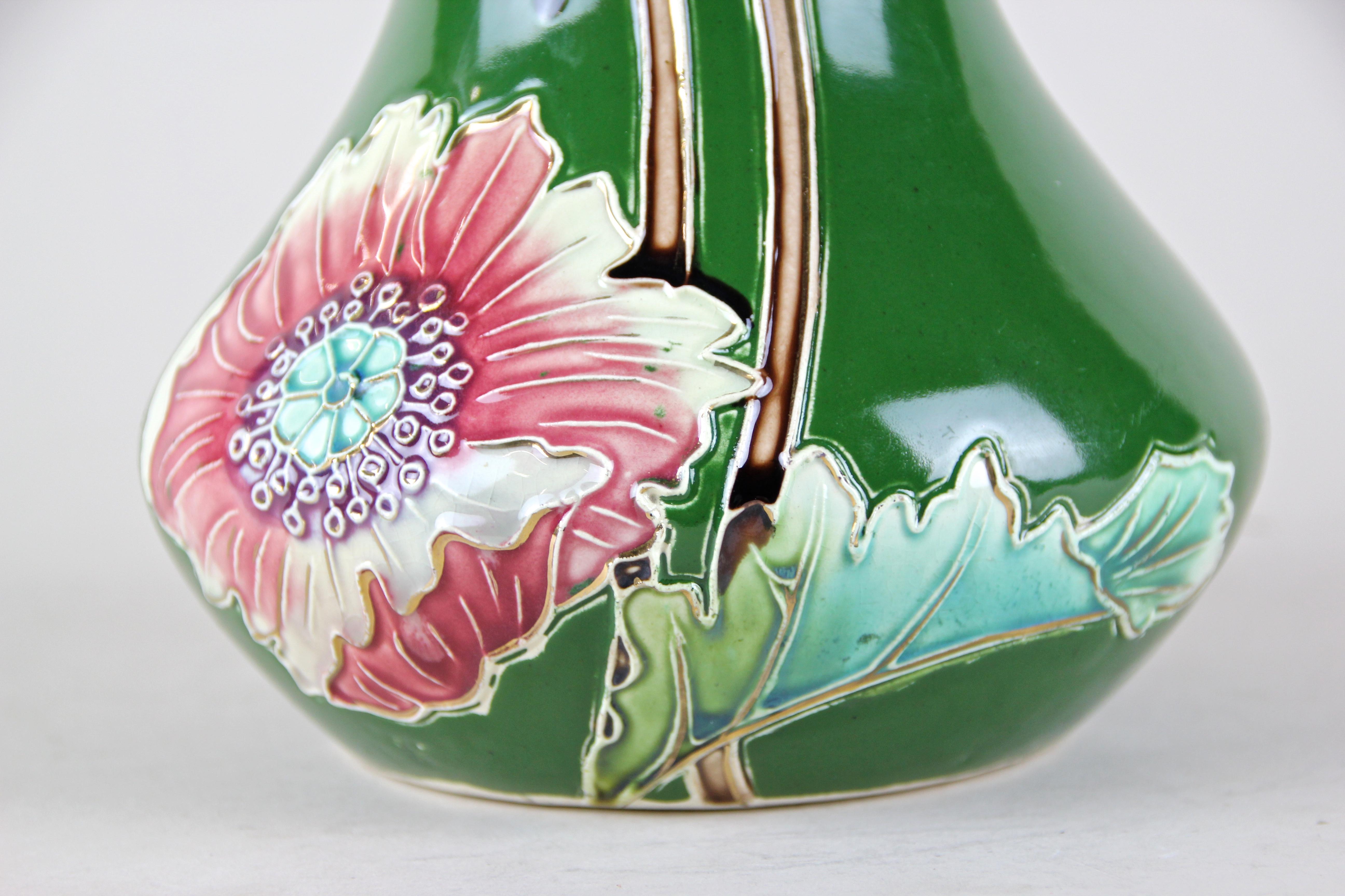 Lovely Art Nouveau vase by Bernhard De Bruyne, France, circa 1910. The wonderful shaped body colored in a beautiful green shows a fantastic floral design with three big blossoms on one side and two on the other. An eye-catching Art Nouveau Vase for