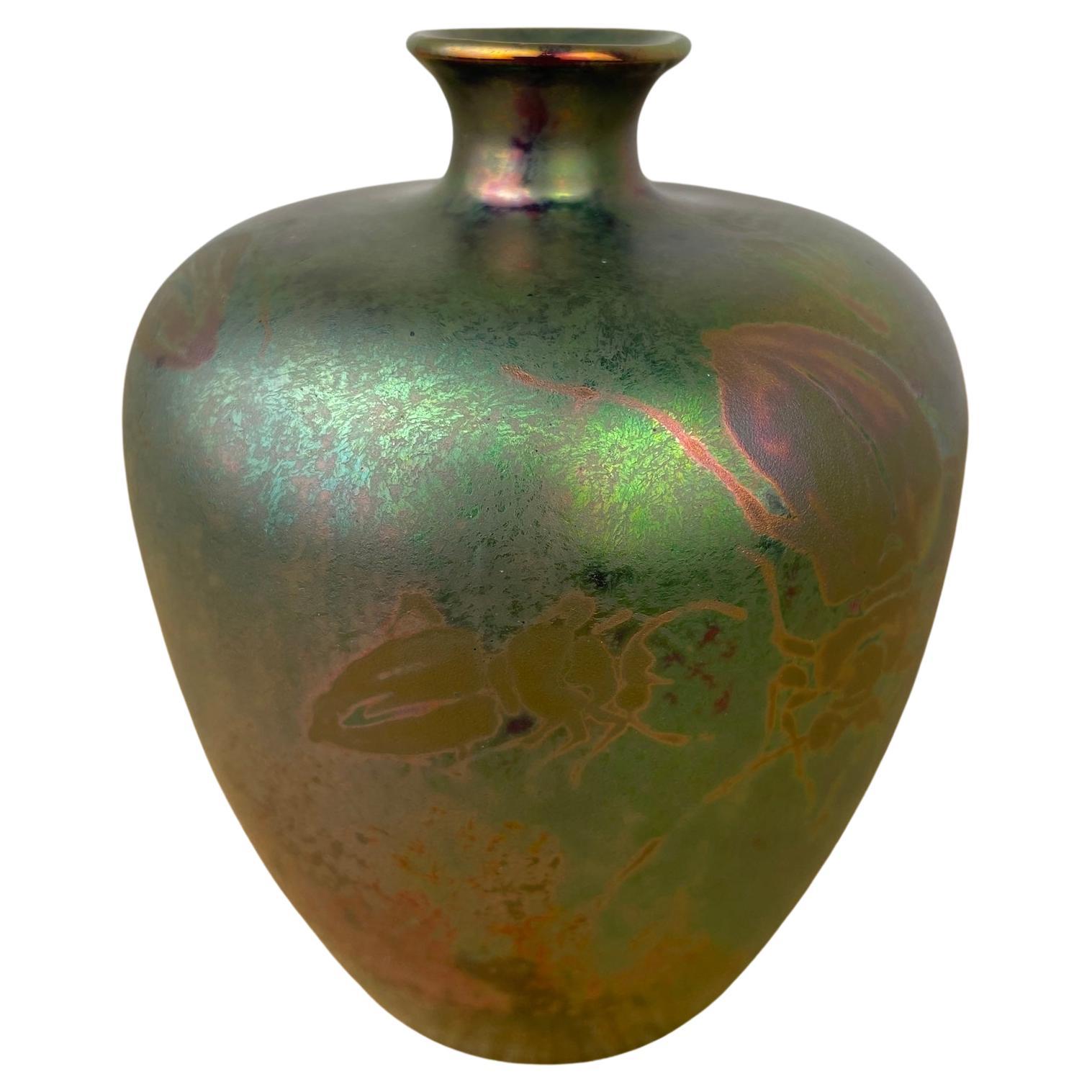 Art Nouveau iridescent lustre pottery vase with floral motif

Artist Clement Massier

Signed to base CM Golf Juan A.M.

French Circa 1900

Height 11cm.  Diameter 9cm 
