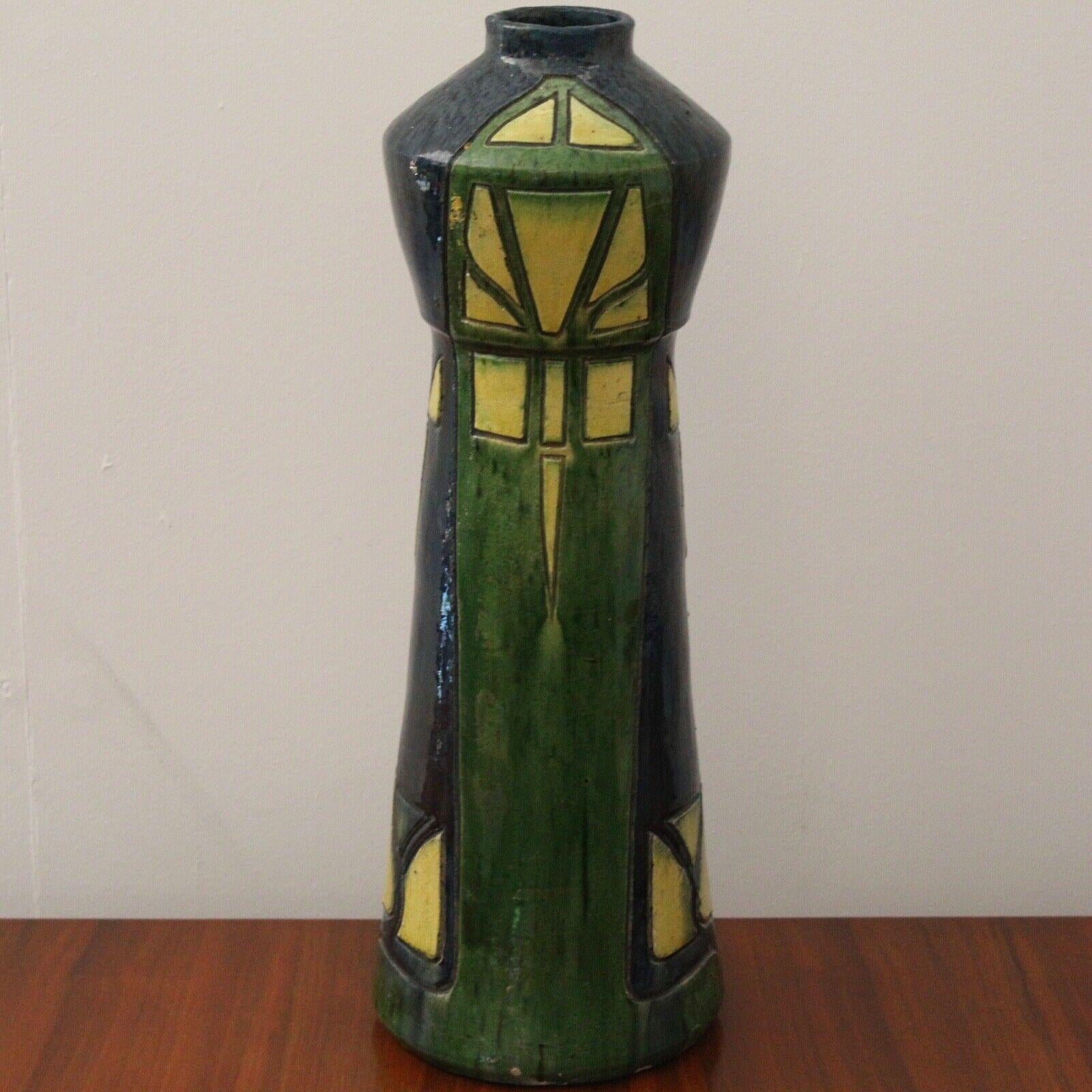 This is a very beautiful Art Nouveau vase painted with deep blues, green and bright yellow. 

Lovely piece in excellent antique condition with no chips or cracks.
   