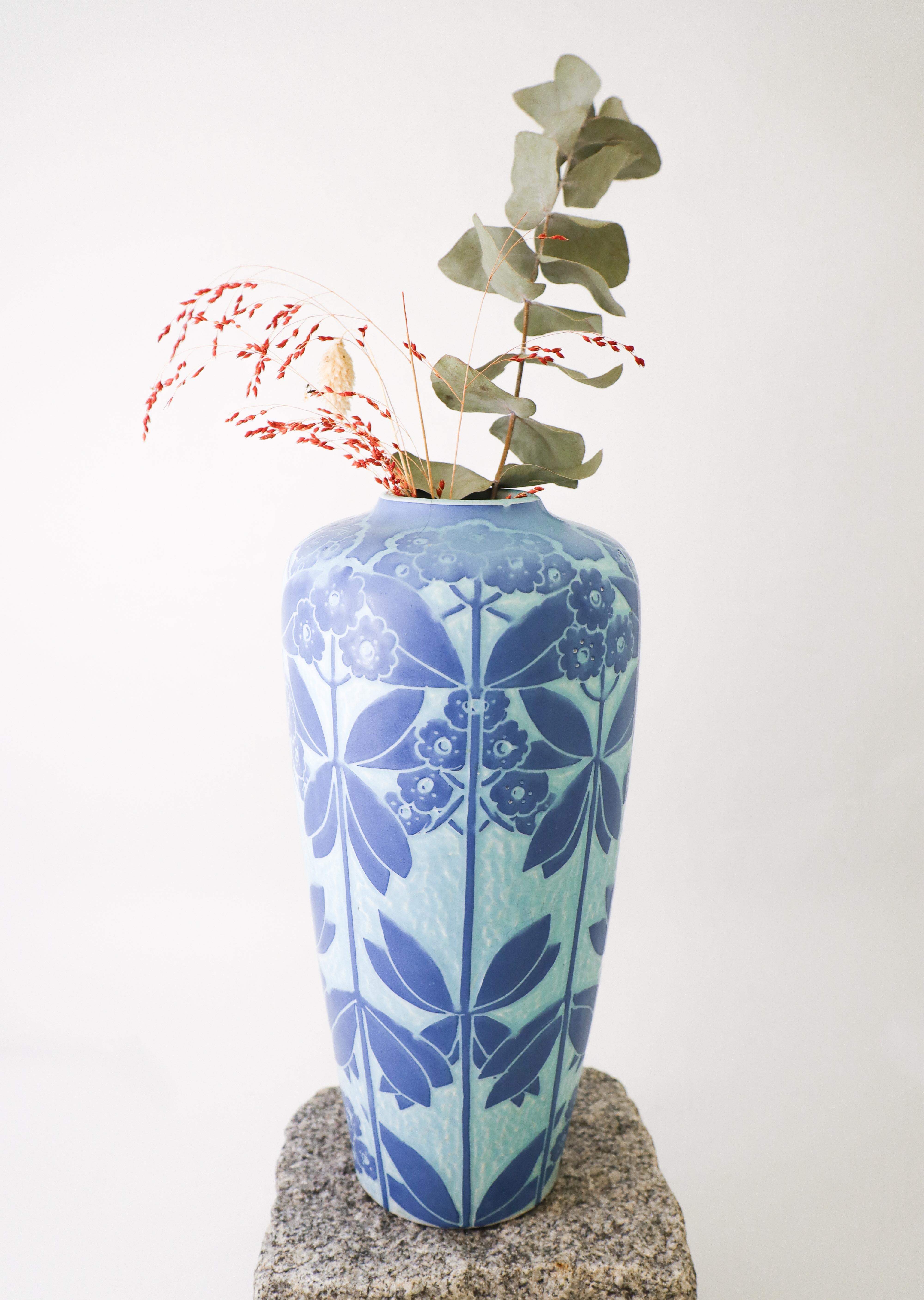 A lovely Art Nouveau vase designed by Elsa Engström at Gustavsberg in 1916. This vase is made in Sgrafitto as Josef Ekberg also did vases during the same time. The vase do have two cracks at the top, see detailed photo except from that it is in