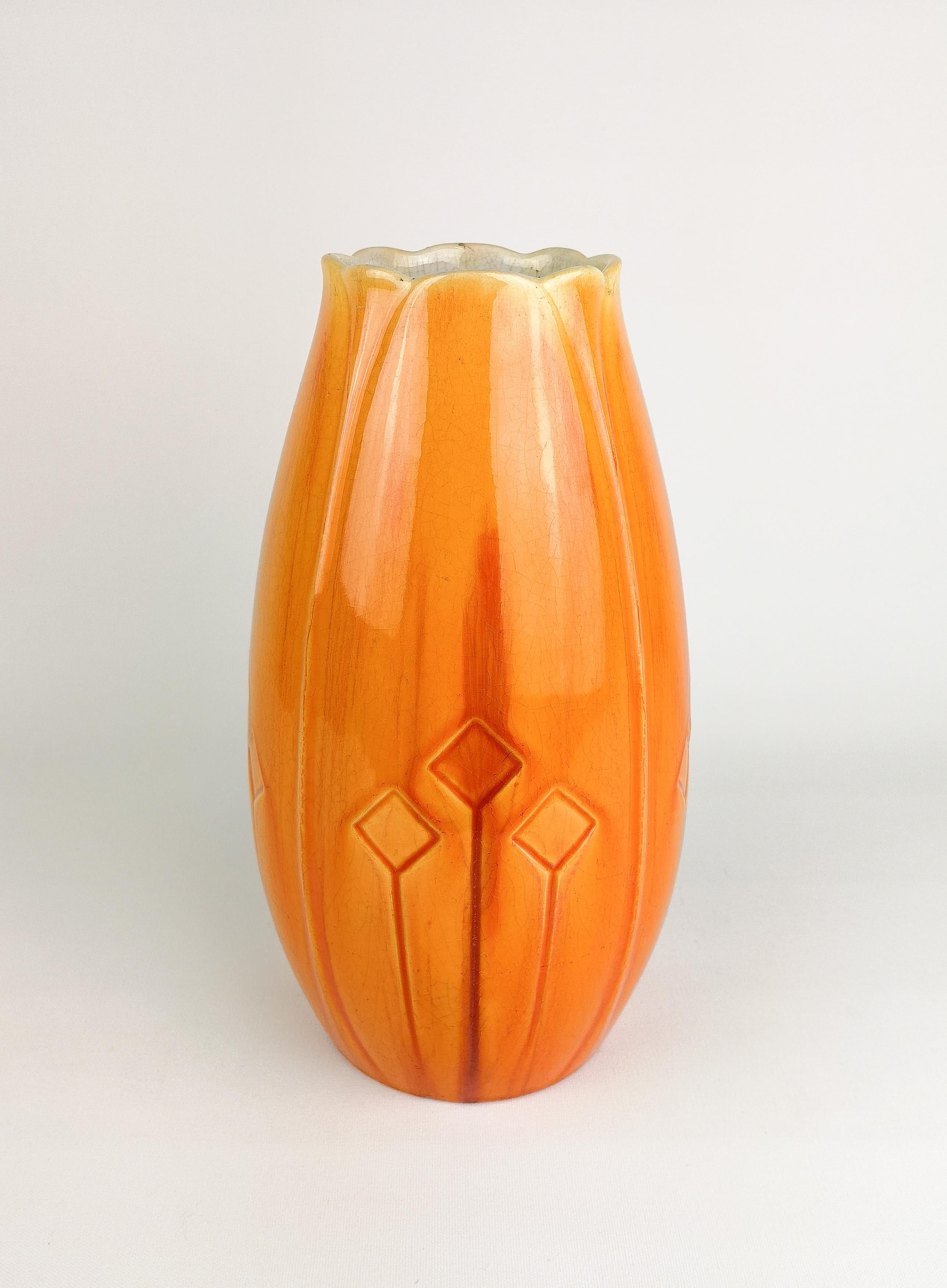 Nicely glazed Art Nouveau vase designed by Alf Wallander for Rörstrand Sweden. The glaze has a wonderful red/orange shine. The vase have some distress marks allaround from its age.
