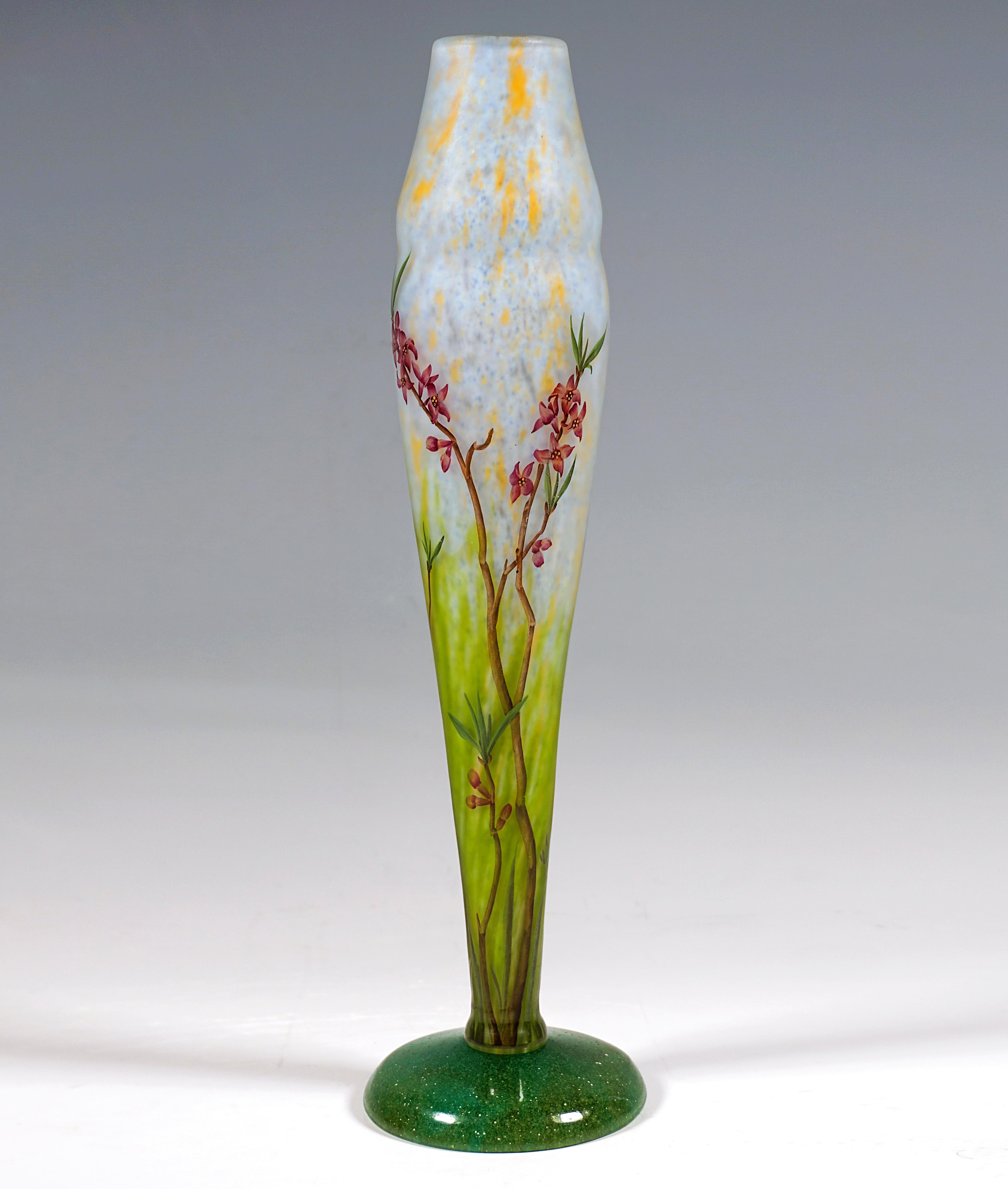 Slender baluster vase, colorless glass with white and yellow, in the lower area with meadow green powder inclusions, arched, flush base with green-turquoise color inclusions, as well as air bubbles, vase body with satin finish, delicate flowering