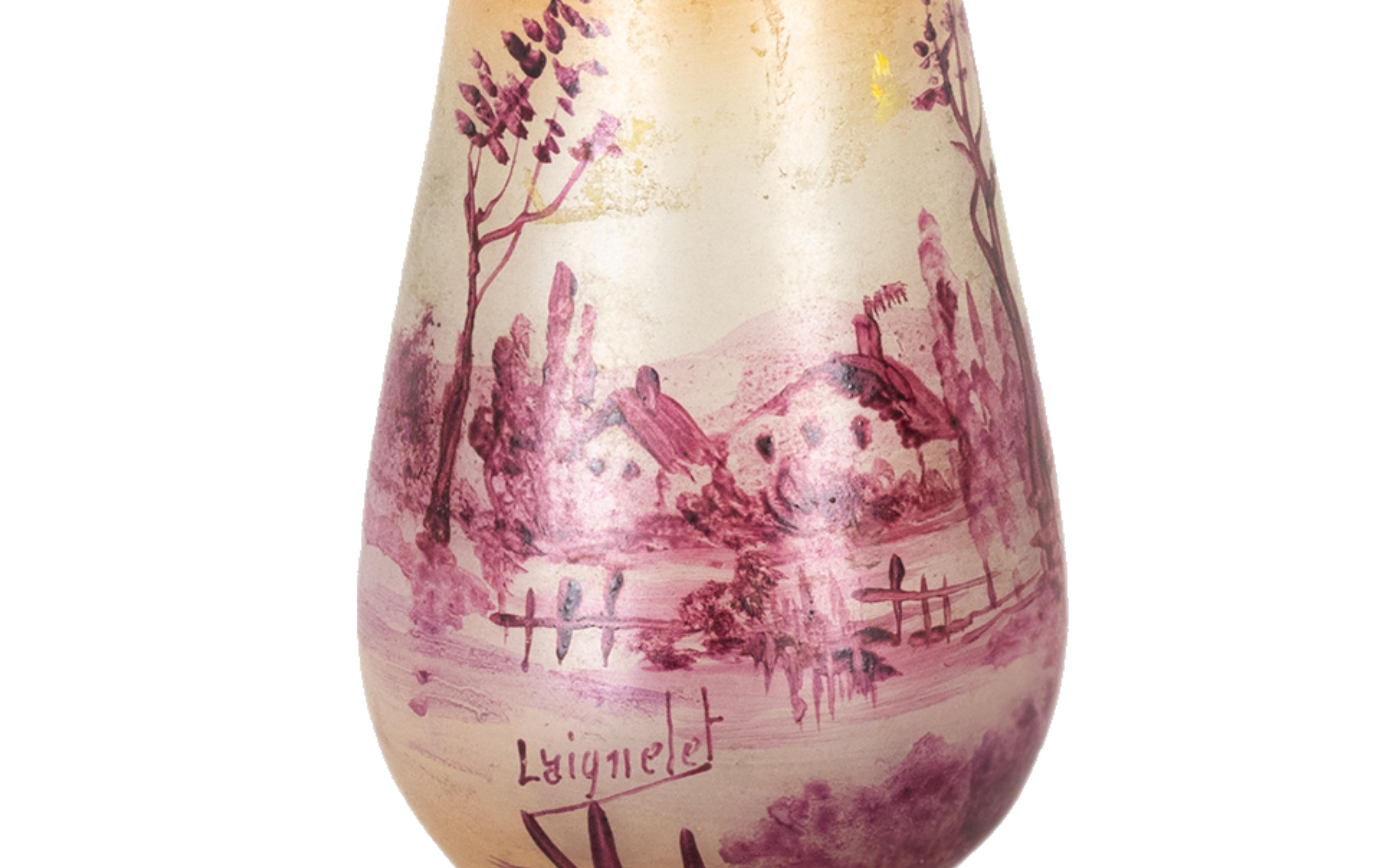 Vase from the Verrerie de Laignelet, signed 'Laignelet' in polychrome glass, with a pink background and a panoramic scene of the Brittany region with its characteristic regional houses.

La Verrerie de Laignelet was created in 1908 by H. Chupin who