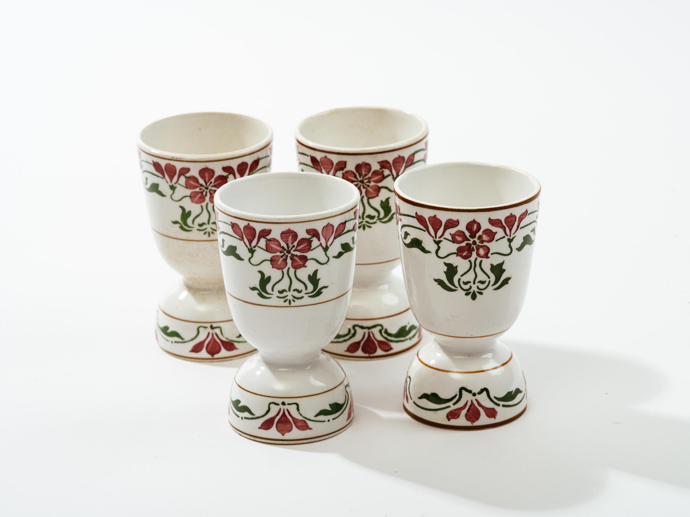 Set of four Jugendstil Saxony Poppy porcelain egg cups by Villeroy and Boch, Dresden,
Germany, dating between 1874- 1909. Beautiful stylized Art Nouveau flower pattern all around white porcelain cups.