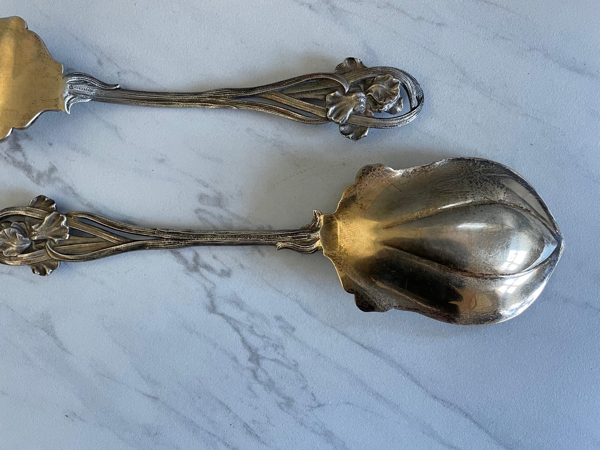 This Art Nouveau vintage sterling Silver salad serving set from Towle features a delicate floral and stem pattern. It includes a fork and spoon large enough for serving.  Pieces are silver, but photos are reflecting light which casts a goldish