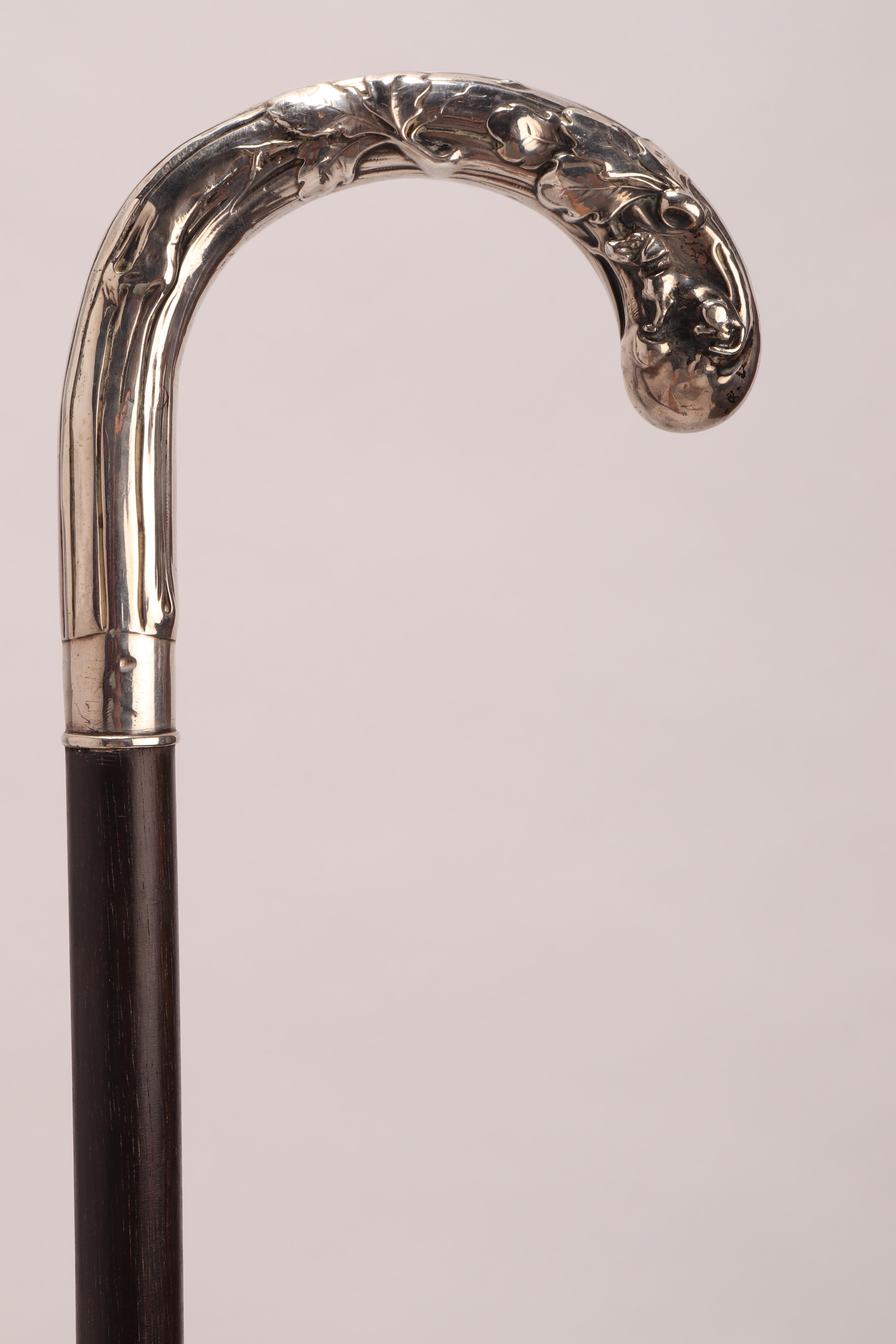 Walking stick: Art nouveau silver handle depicting a dog with acorn leaves. Ebony wood shaft. Metal tip. Germany 1890 ca.