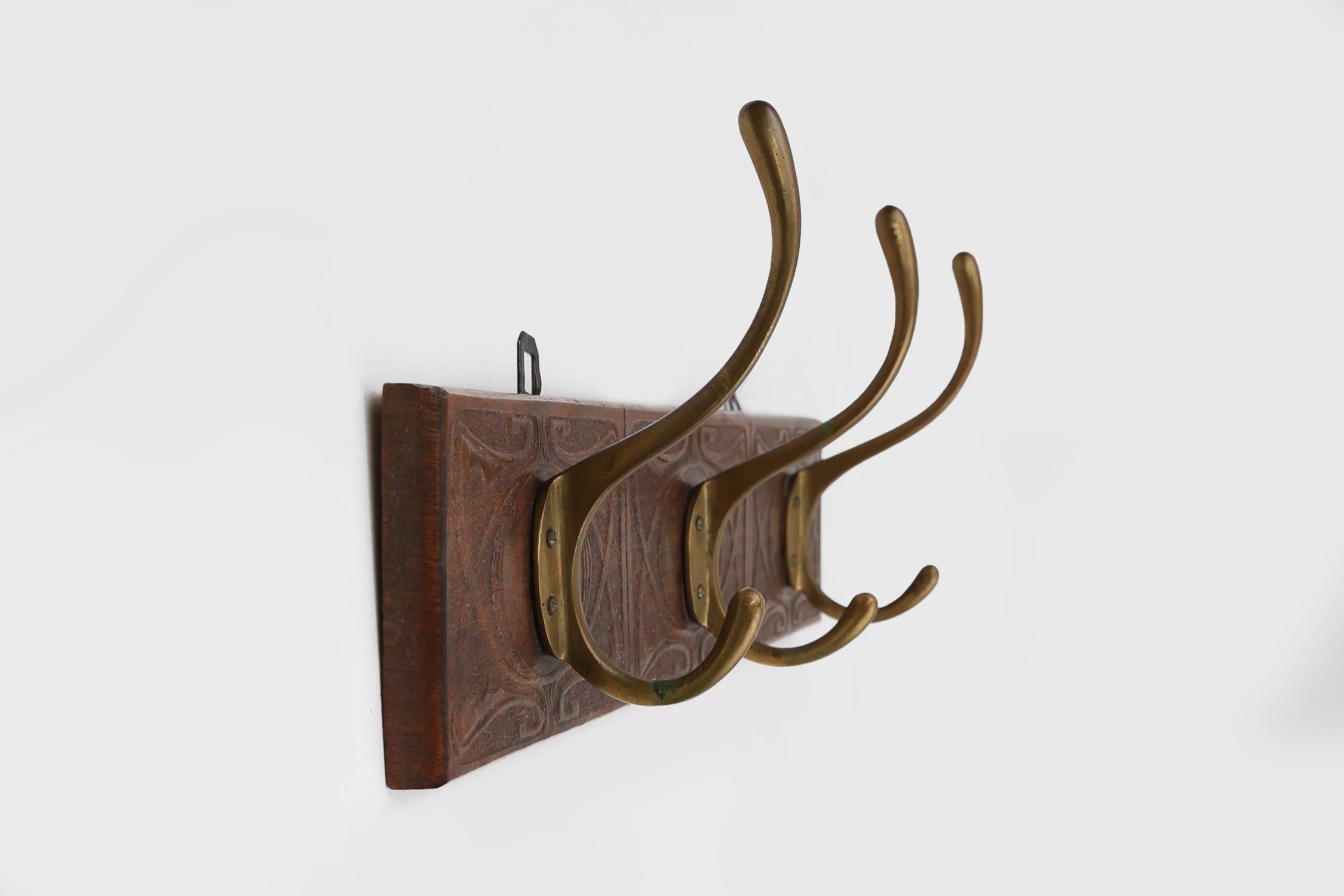 Hand-Carved Art Nouveau wall coat rack in carved wood with brass, France ca. 1910 For Sale