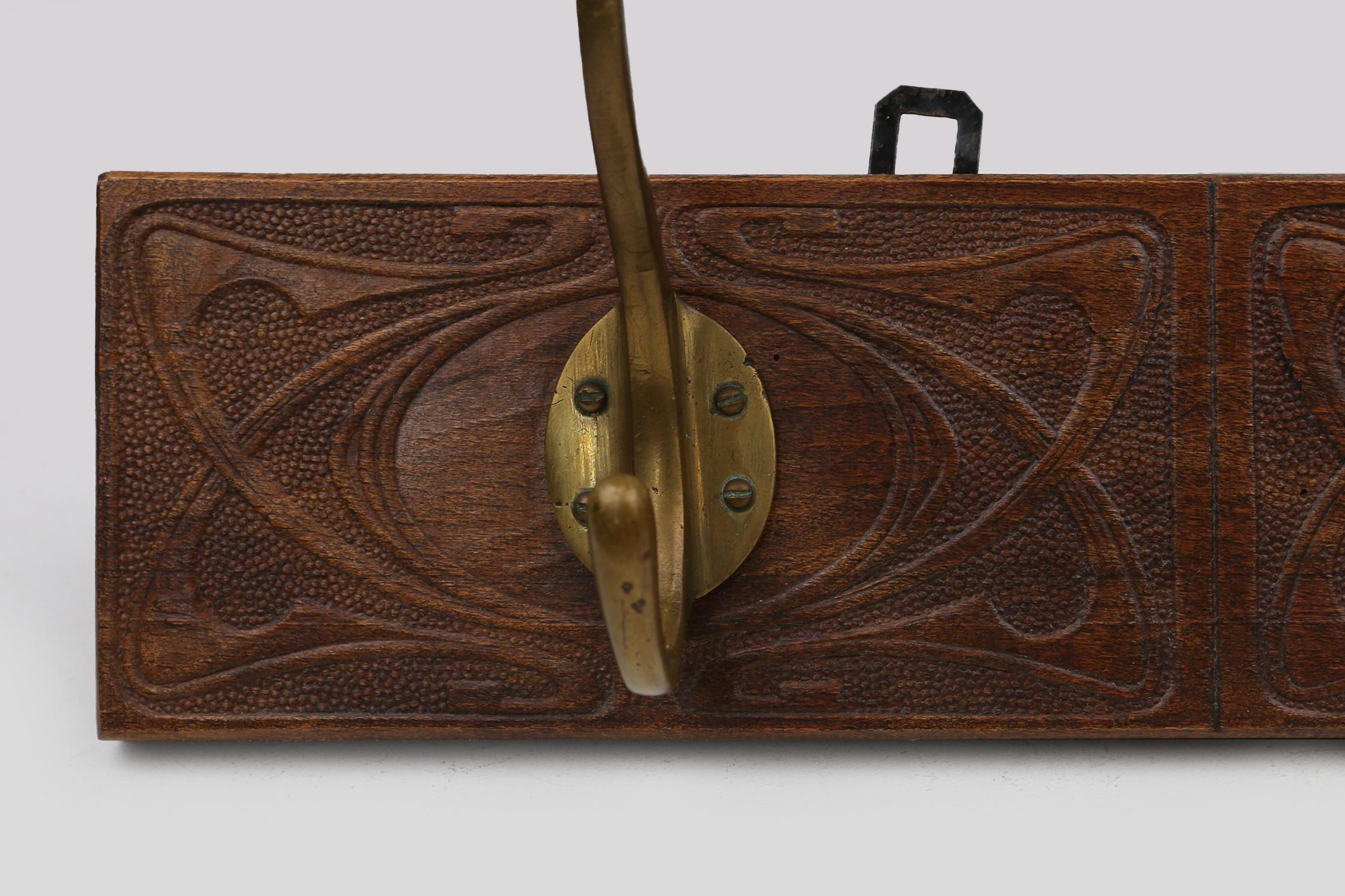 Early 20th Century Art Nouveau wall coat rack in carved wood with brass, France ca. 1910 For Sale