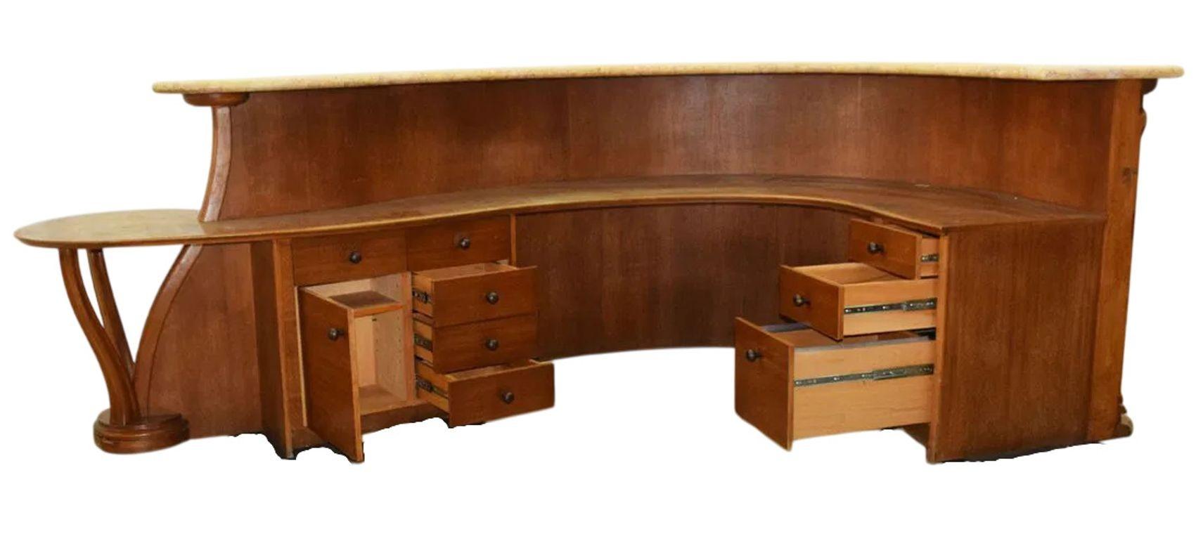 A stunning and substantial Art Nouveau style gallery counter or reception desk, made circa 1920's. Crafted in the United States, this impressive piece showcases masterful woodworking in walnut with burl veneer inset panels. Its sweeping curves,