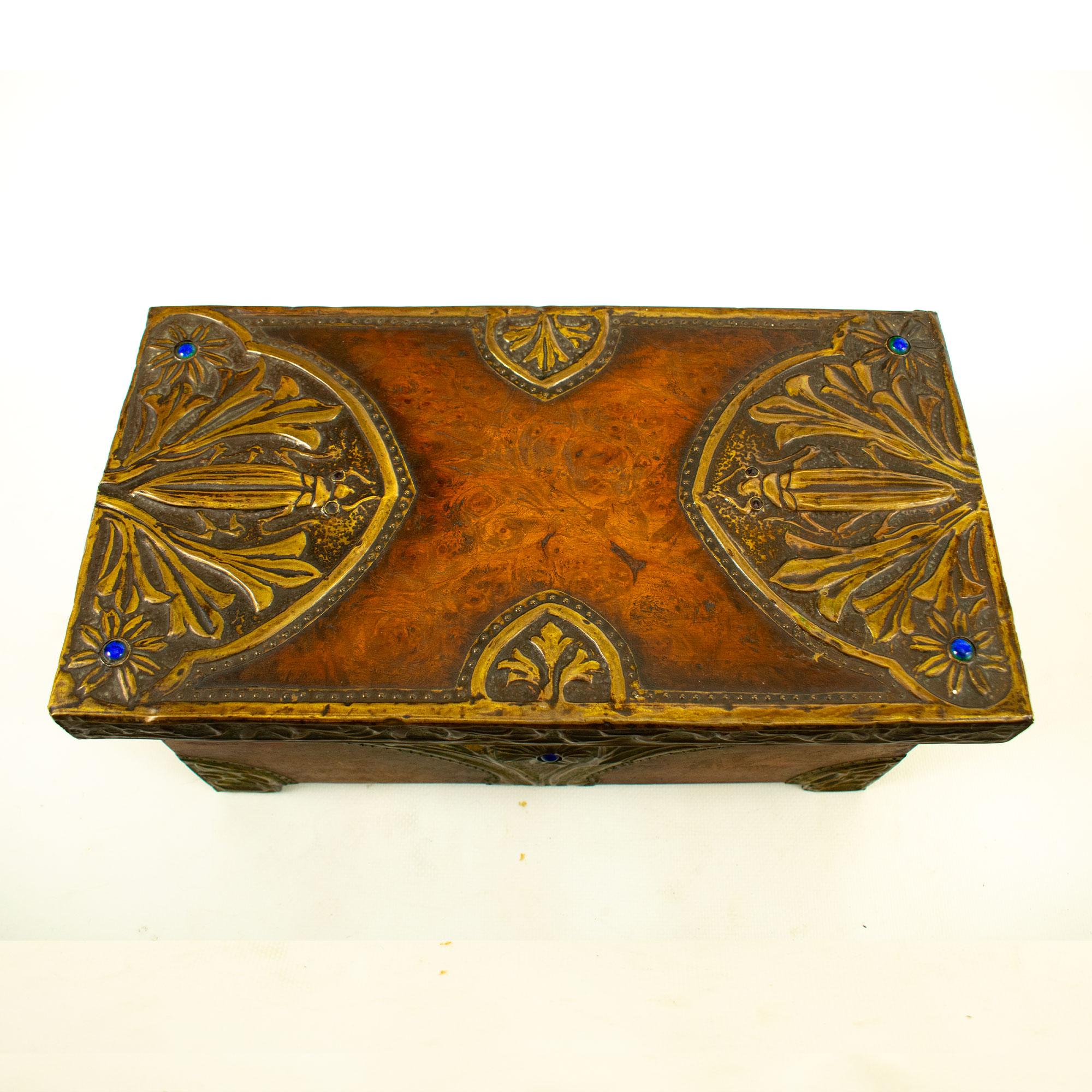 Very pretty rectangular walnut chest with embossed bronze decoration in the Art Nouveau style, depicting scrolls, scarab beetles, foliage and flowers - a typical organic style which was prominent in the Art Nouveau period. The pistils and detail
