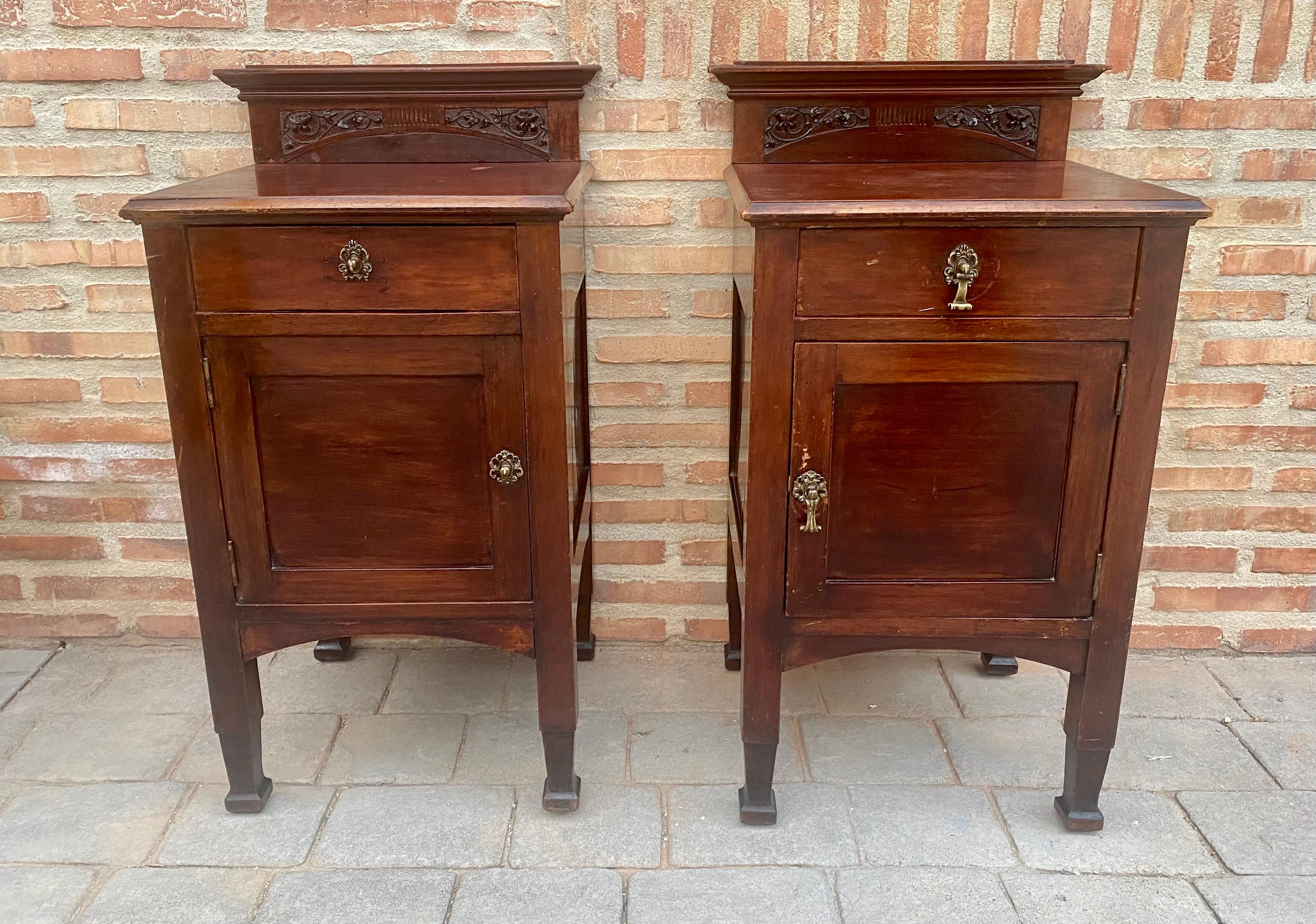 Pair of late 19th century Art Nouveau nightstands with carved tops, bronze handles, restored and wax polished. 
We observe small defects of use, but they are delivered completely restored, preserving their beauty and original conditioning of the