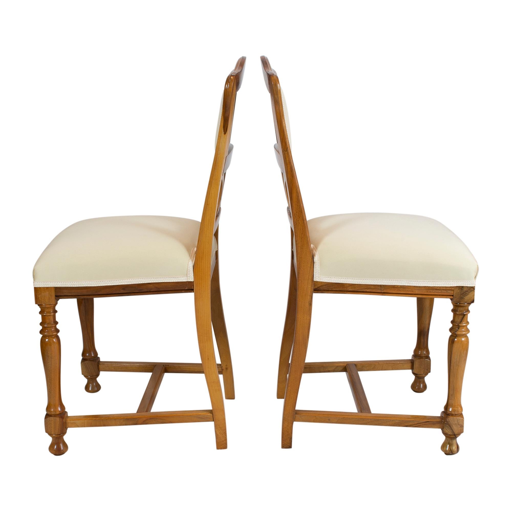 Beautiful pair of chairs from the Art Nouveau period in solid walnut wood. 
The chairs are reupholstered and covered with new fabric. In very good restored condition.