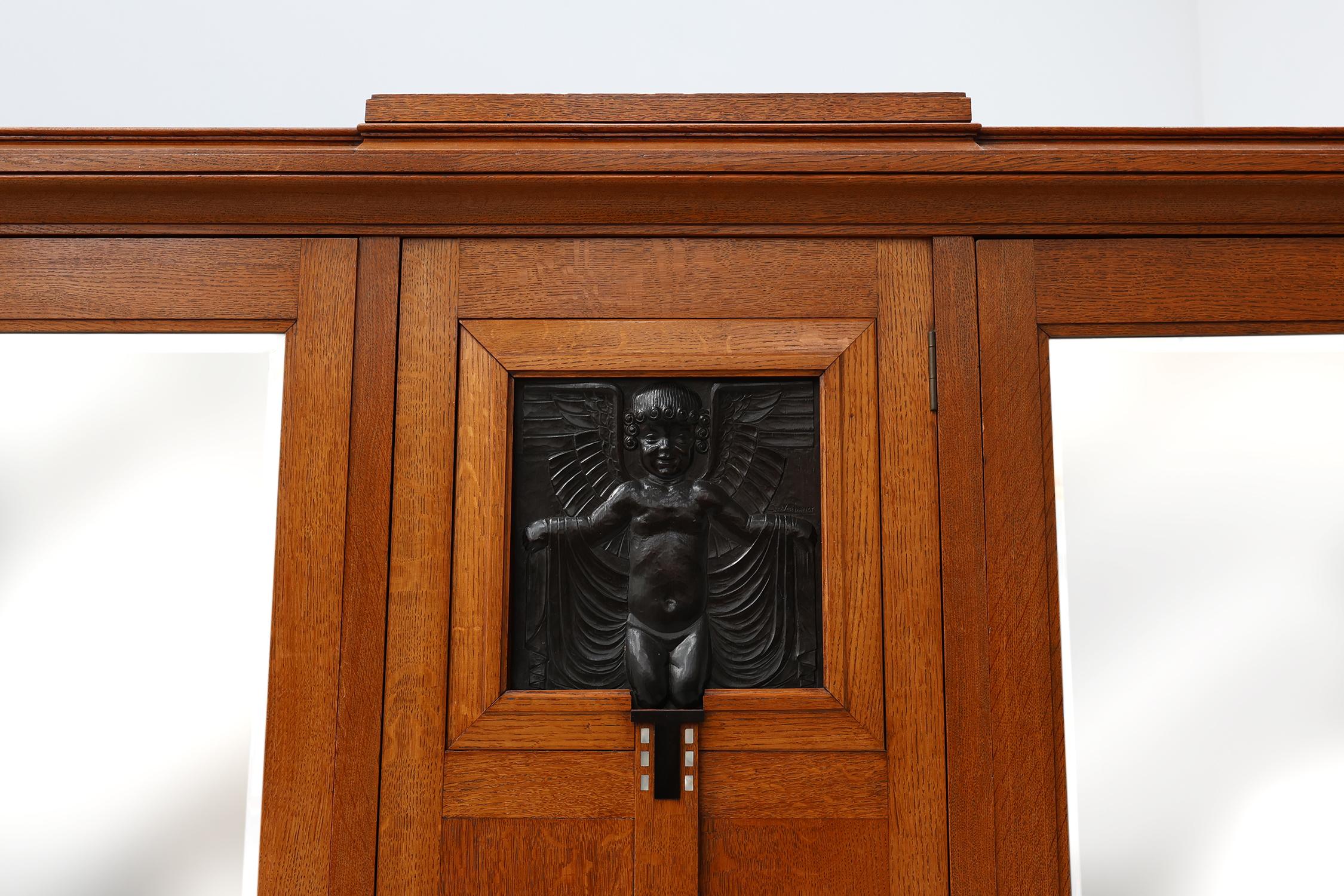 Belgium / 1905 / Wardrobe / De Coene/ Geo Verbanck / oak, copper / Art Deco / Art Nouveau

A stylish Art Nouveau wardrobe or armoire in solid oak most likely designed by De Coene, Kortrijk with a copper plaque signed by the Belgian artist Geo