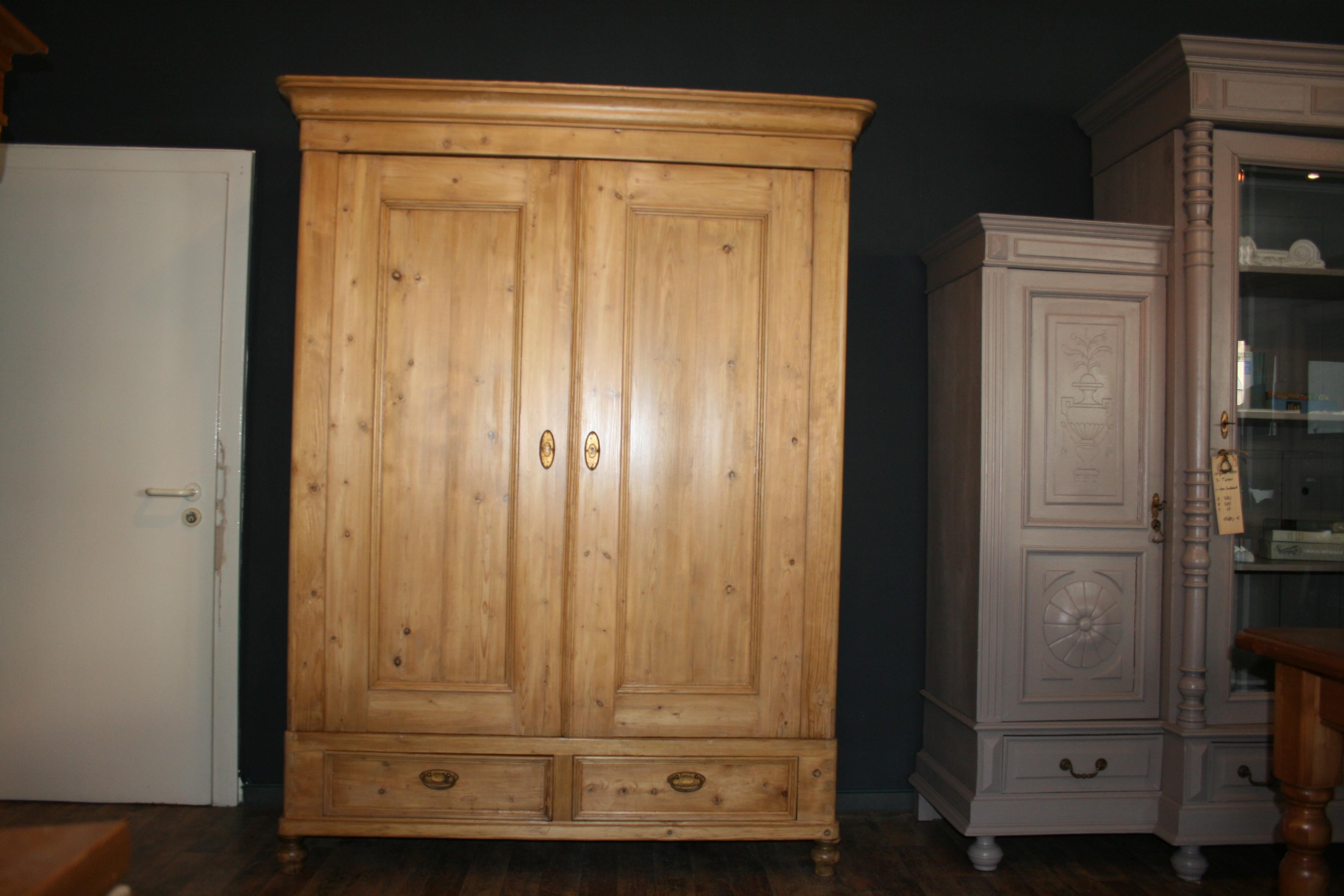 German Art Nouveau cabinet made of fir wood. 2 doors and 2 drawers with original brass fittings. Can be dismantled in several parts with wooden wedges. Restored.
 