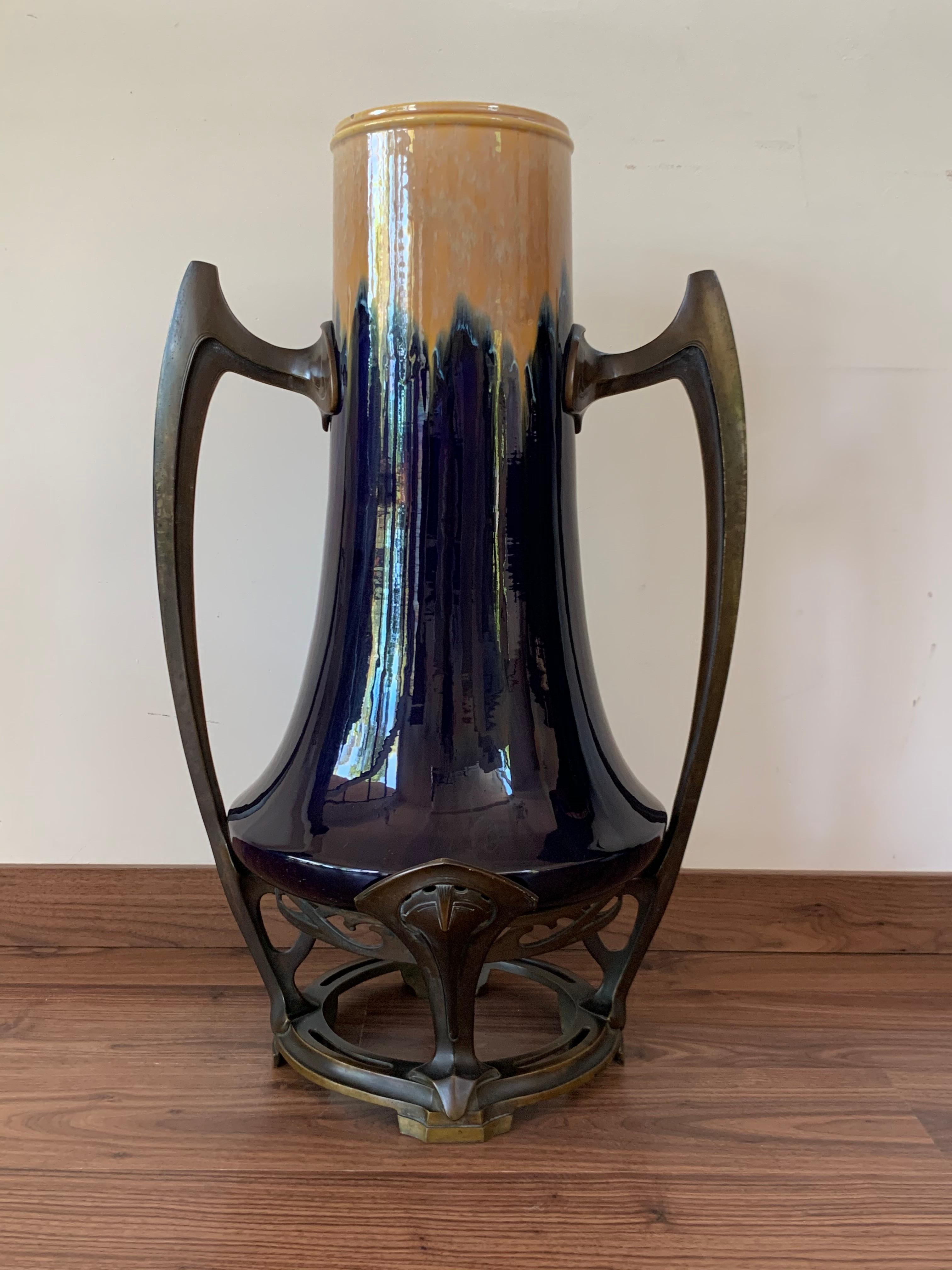 Jugendstil ceramic vase bronze mounted is an original decorative object realized in the early 20th century.
Original ceramic vase with cream and cobalt blue glaze. All around colorful.

 