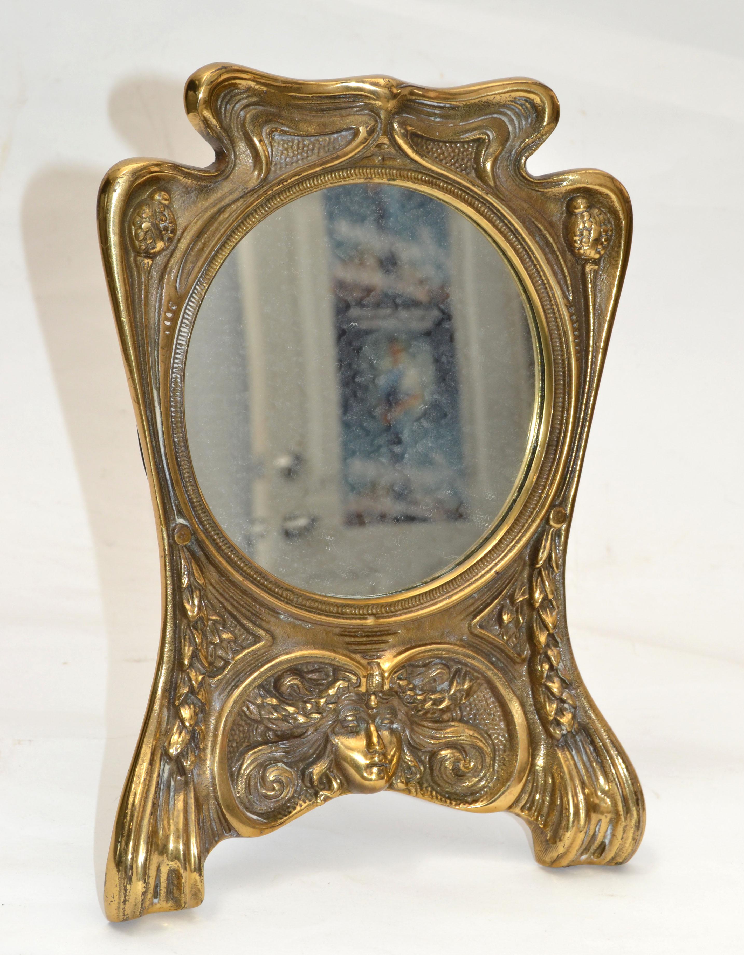 Art Nouveau whimsical handcrafted cast bronze table or vanity mirror.
Mirror size: 5.25 inches diameter.