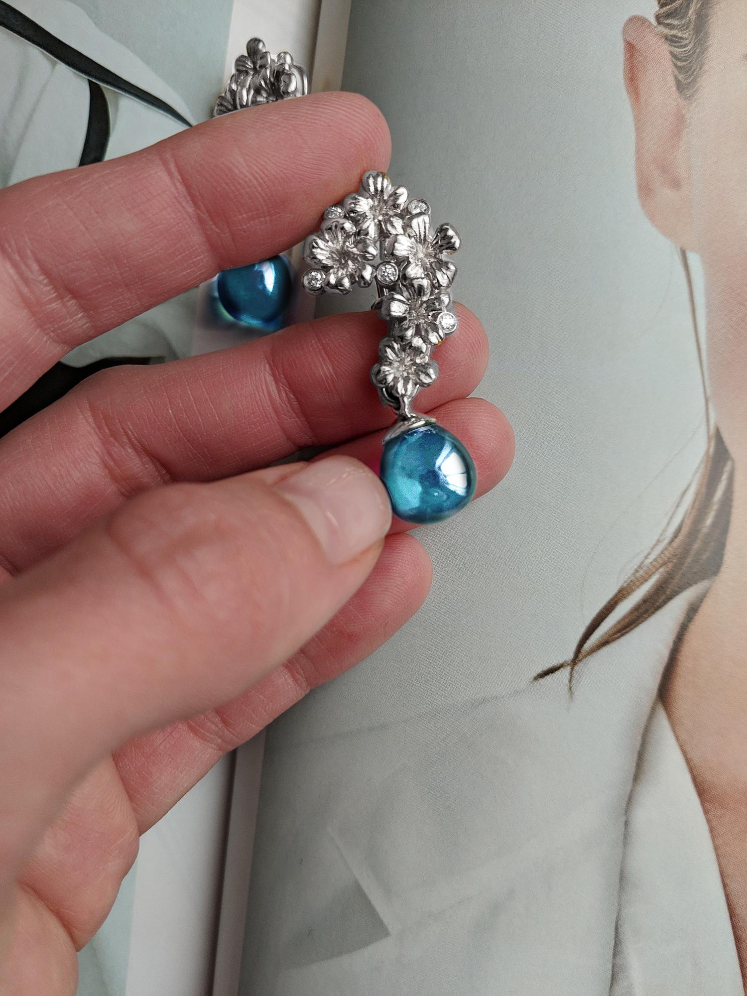 18 karat white gold Plum Blossom brooch is encrusted with 5 round diamonds and topaz. This jewellery collection was featured in Vogue UA and Harper's Bazaar reviews. We use top natural diamonds VS, F-G, and work with a German gems company that has