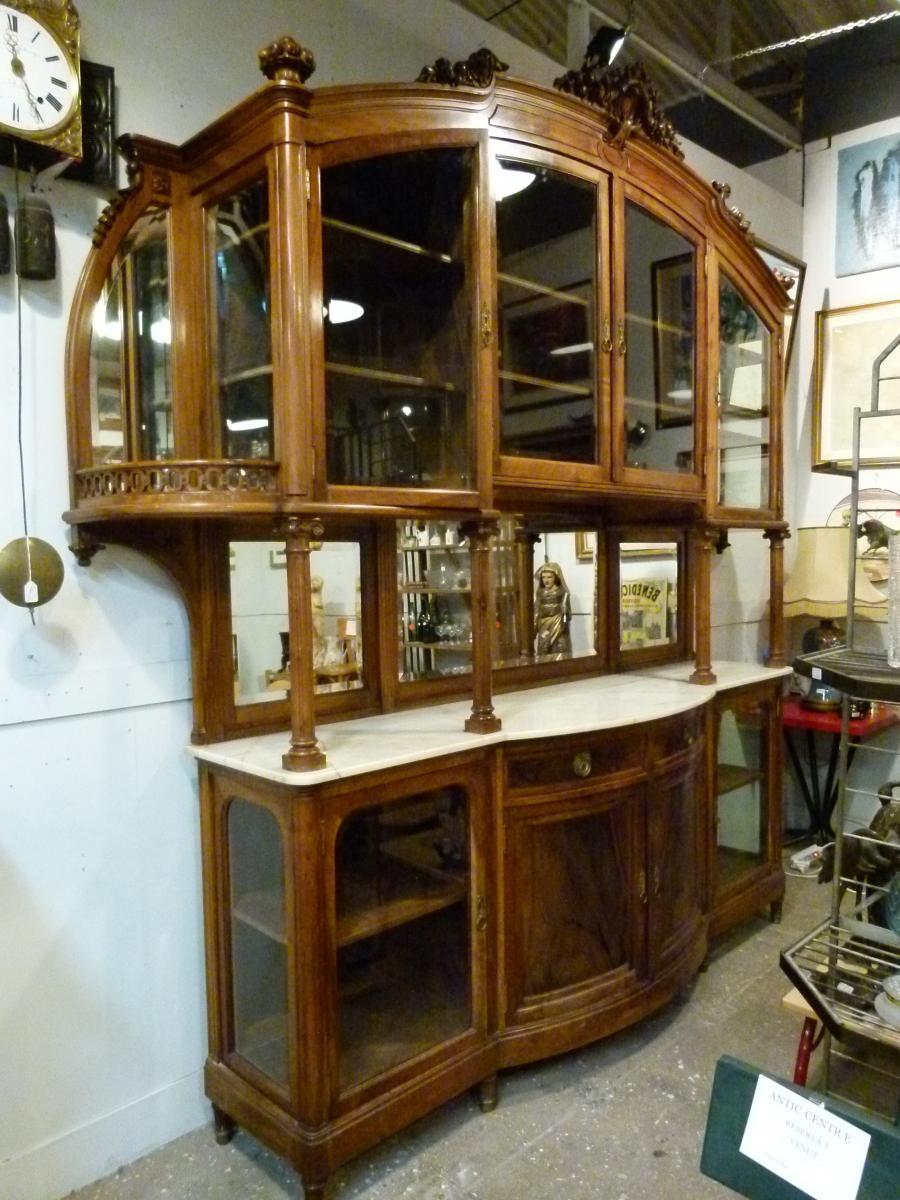 Art Nouveau cabinet, that belonged to a bourgeois family's house near Barcelona.
The upper part features 4 glass doors and two wooden shelves - Part of the interior background in both extremes are mirrors- On both exterior sides two small carved