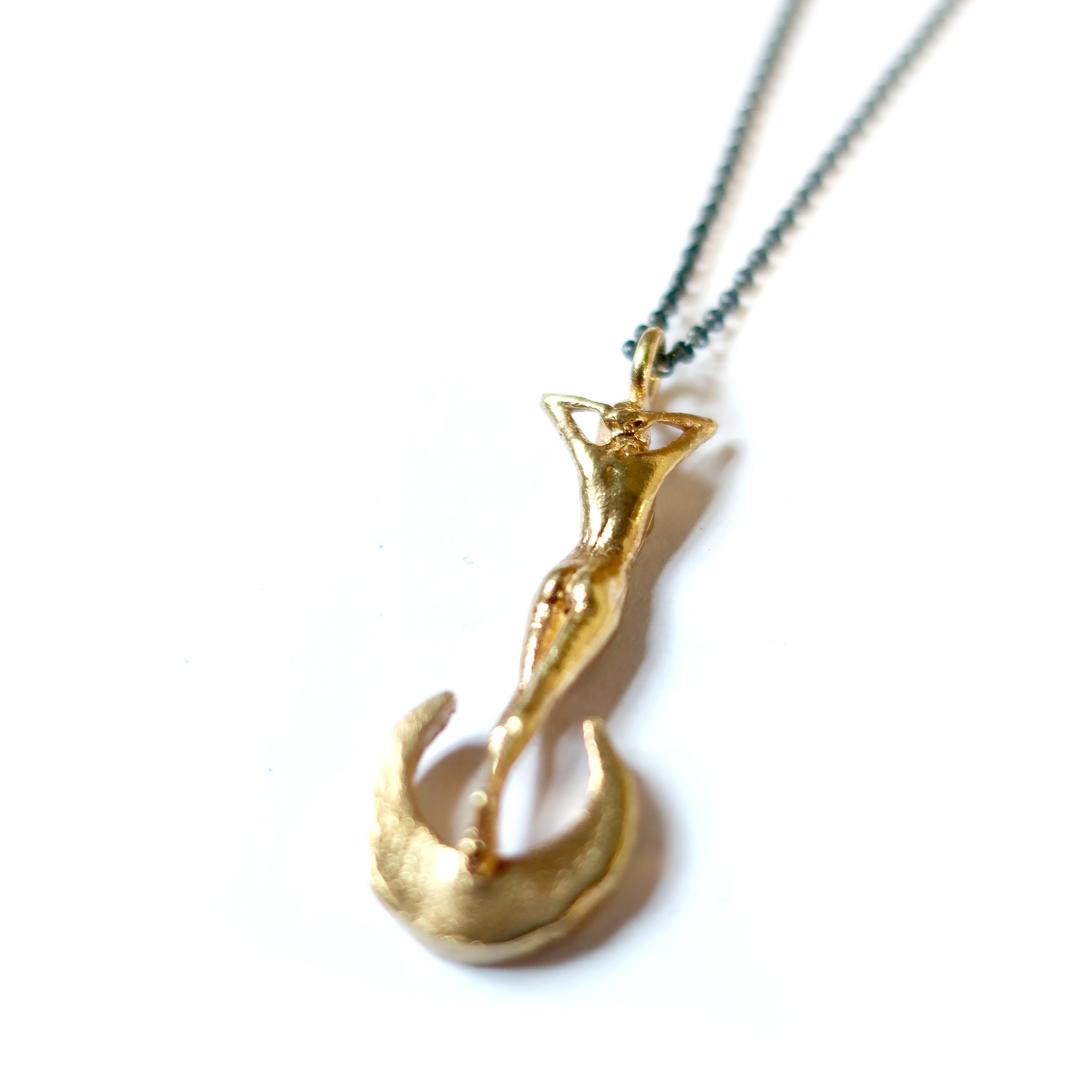 Cast in solid 14k yellow gold this statuesque woman perched atop a crescent moon is a stunning ode to classic art nouveau themes in jewelry. Strung on a solid 20 inch twisted rope chain this pendant measures 33mm in height.  The moon is bead set