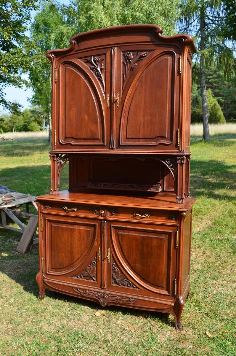 - Art Nouveau buffet, circa 1900 
- French piece in the Nancy school style 
- Carved poppies, thistles, and various flowers 
- Bronze hardware 
- Close in style to the productions of Majorelle, Dumas, Diot, and others.

Detailed condition: