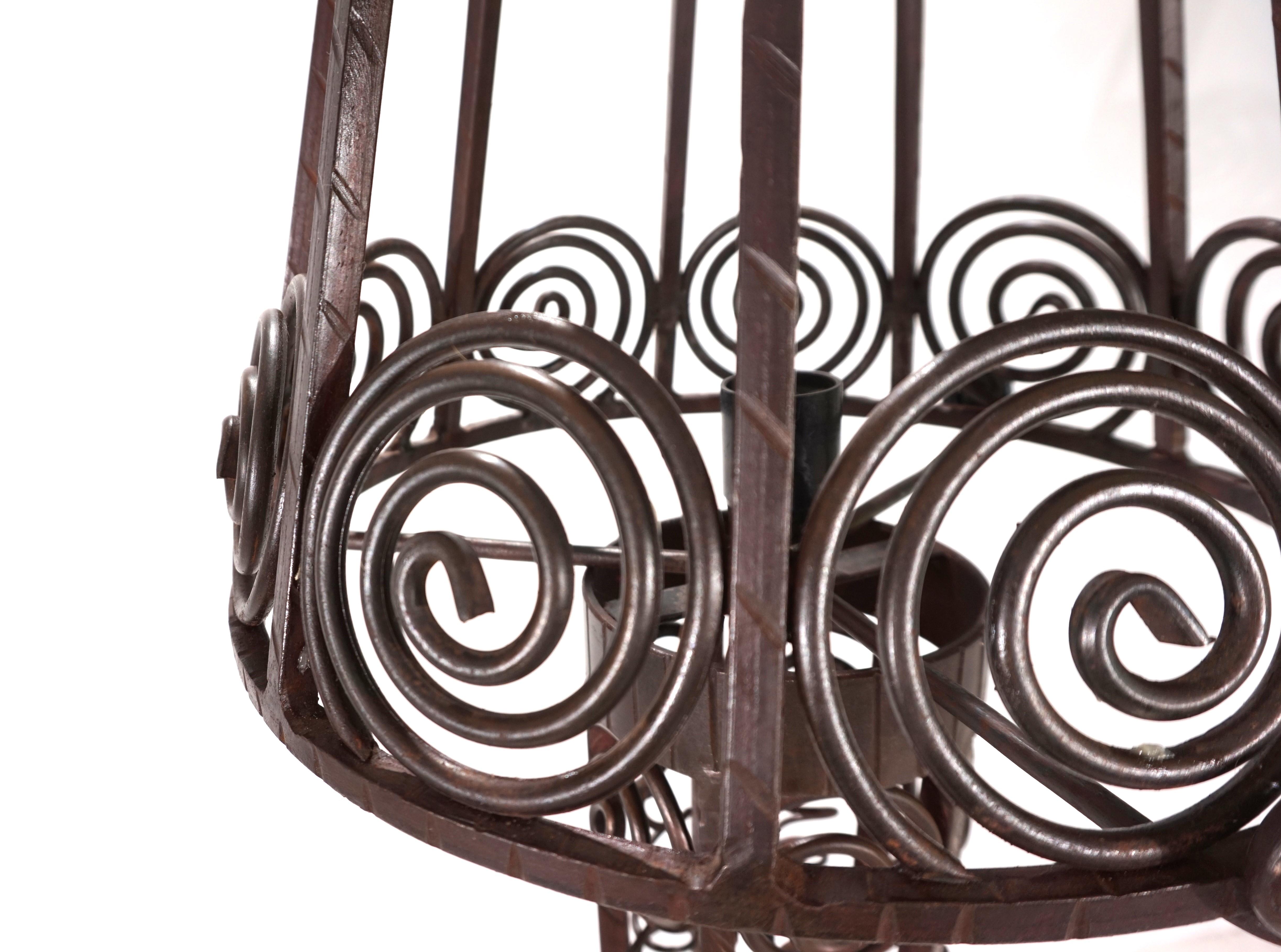 This solid wrought-iron floor lamp is in excellent condition with a beautiful patina. The iron frame, with leaf and floral ornamentation repeated on the base and lampshade, is of first-class craftsmanship and, given its weight, provides the entire